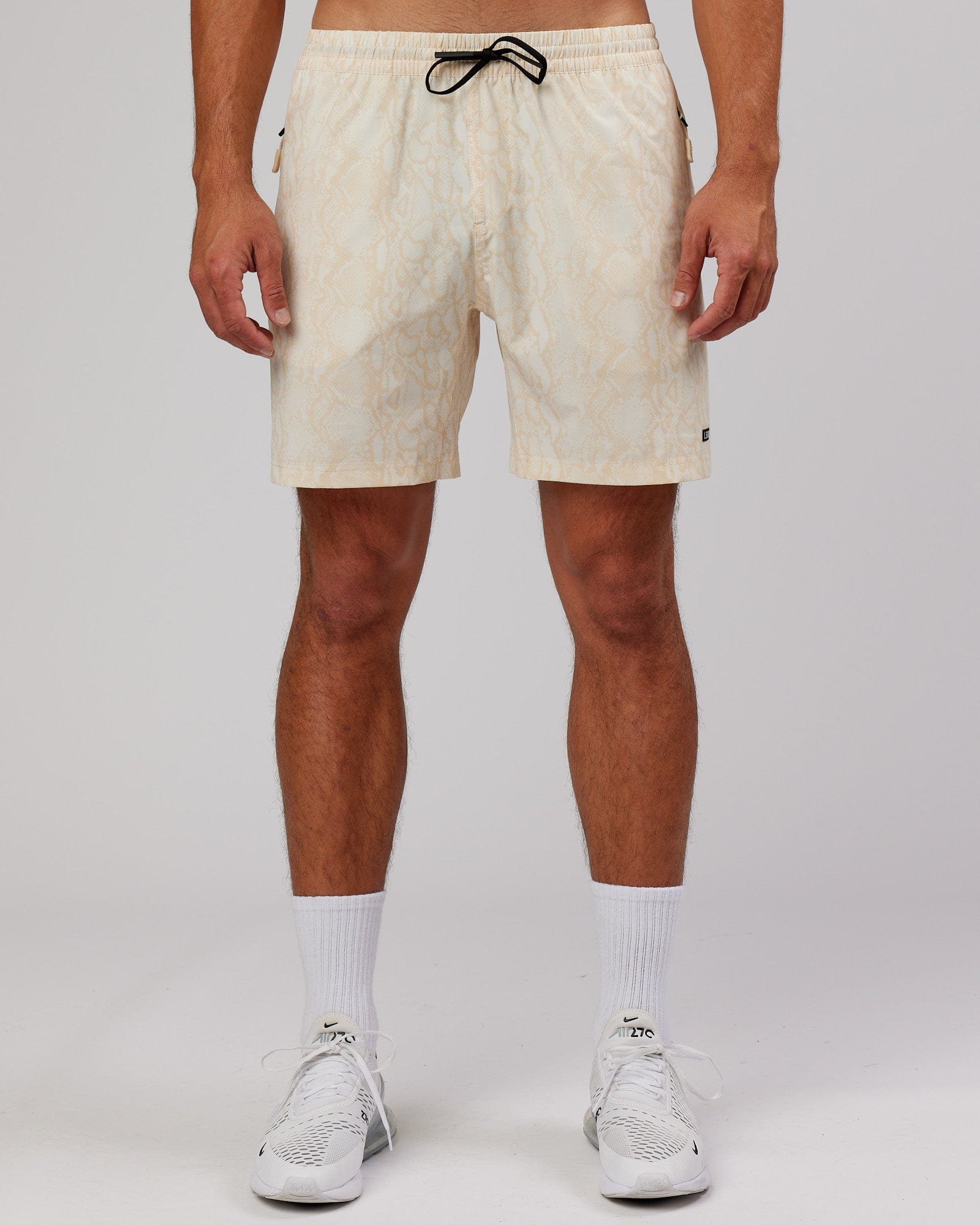 Model wearing Rep 7'' Performance Short - Almond Snakeskin
