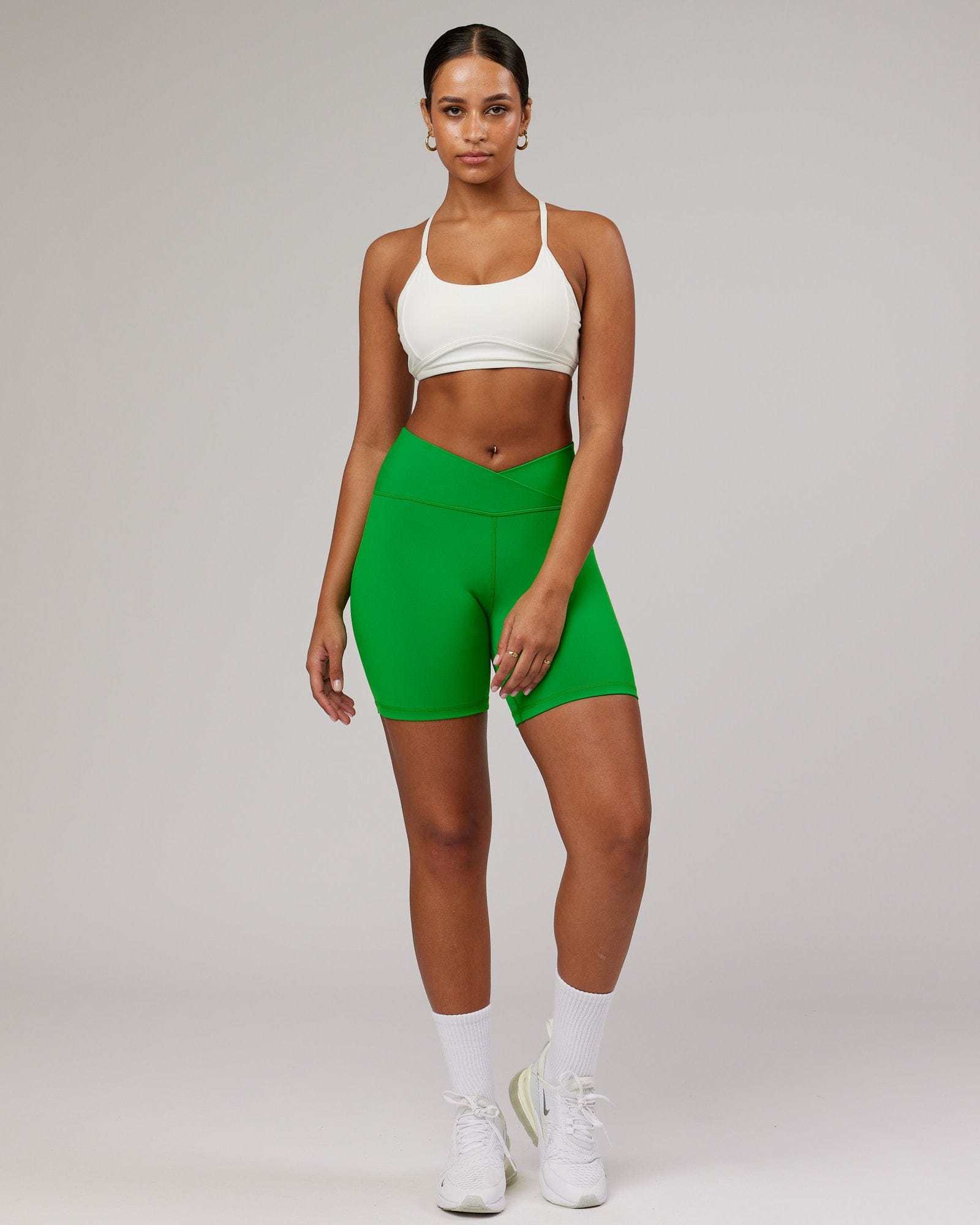 Model wearing Strike Mid Short Tight - Vivid Green