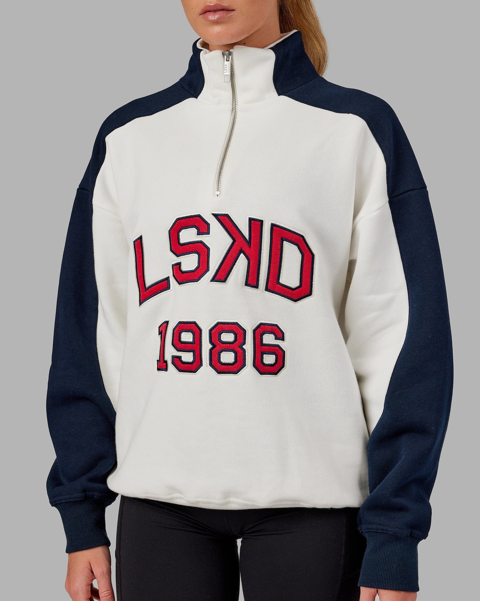 Model wearing Unisex Alumni 1/4 Zip Sweater Oversize - Navy-Red