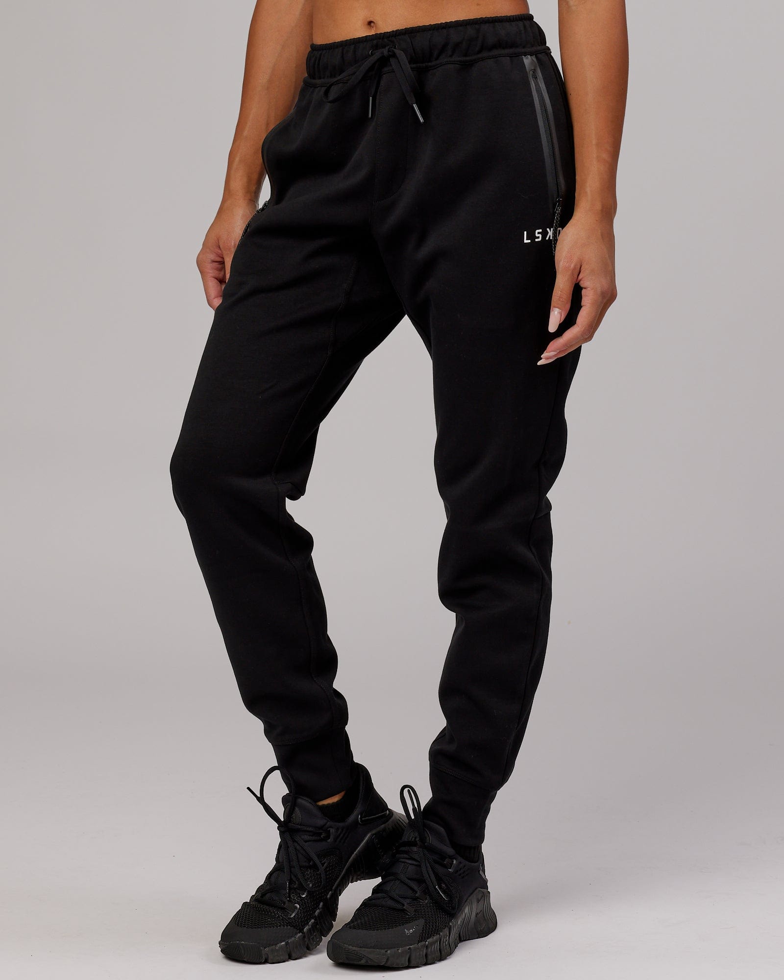 Model wearing Womens Athlete ForgedFleece Trackpant - Black
