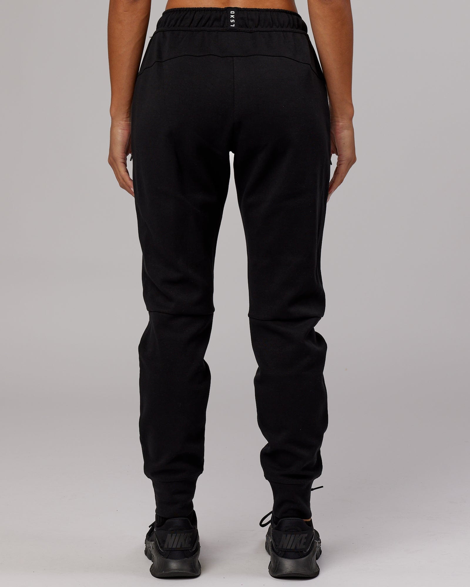 Model wearing Womens Athlete ForgedFleece Trackpant - Black