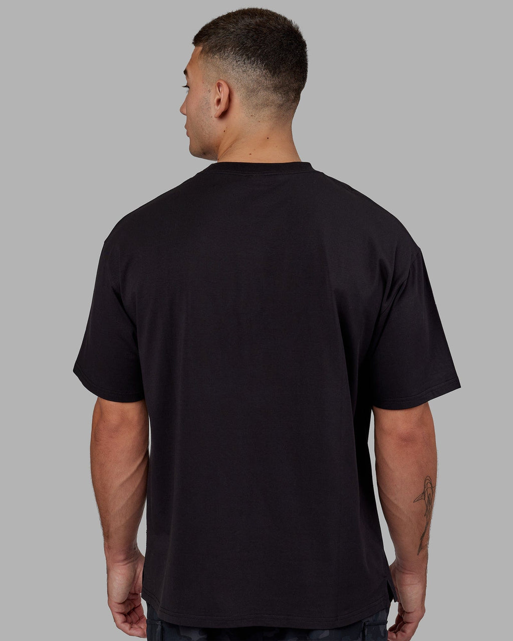 Man wearing Unisex 1% Better FLXCotton Tee Oversize - Black