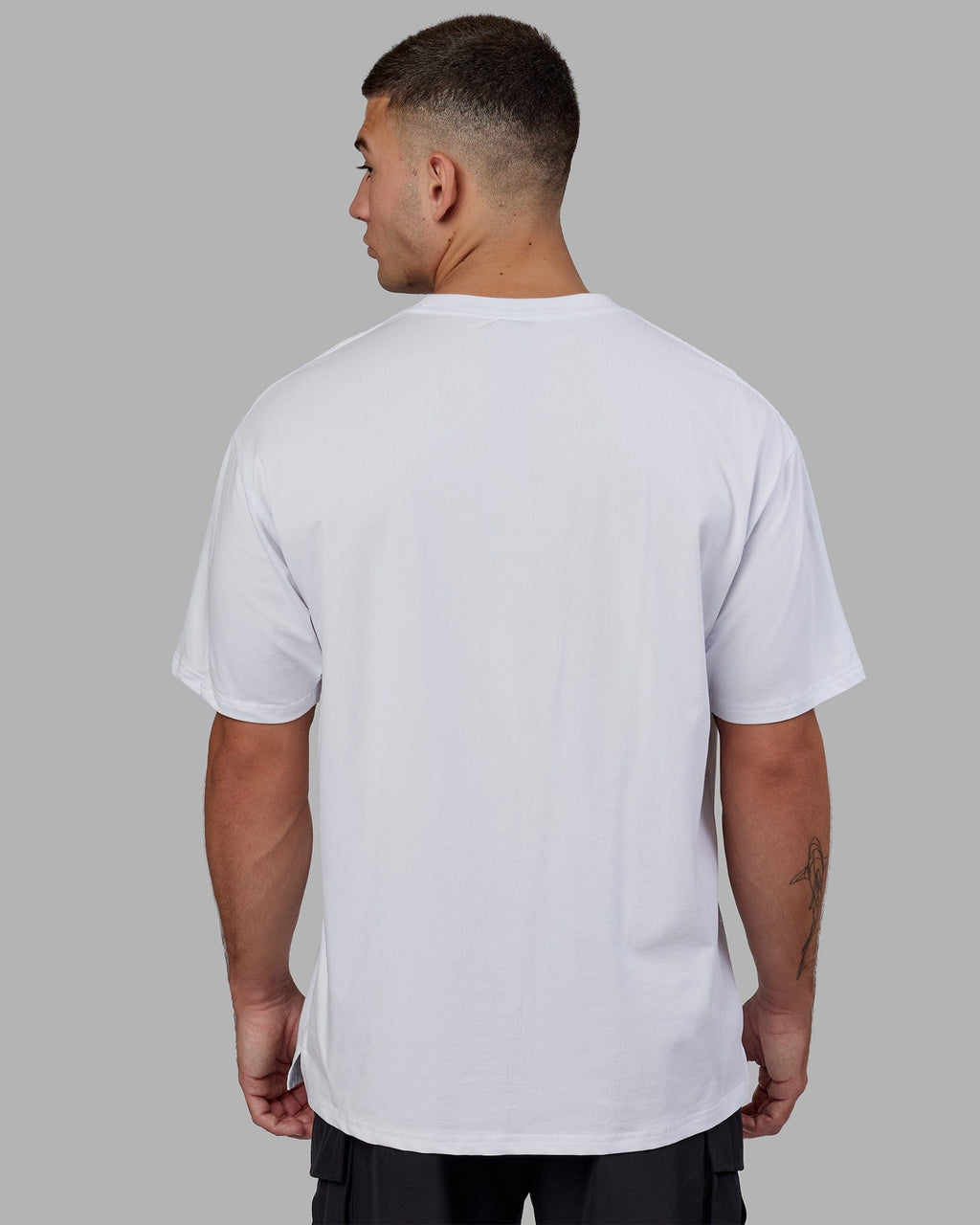 Man wearing Unisex 1% Better FLXCotton Tee Oversize - White