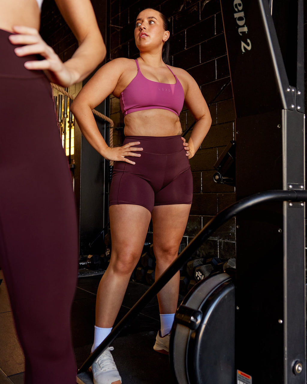 Woman wearing Elite Mid-Length Shorts - Dark Cherry