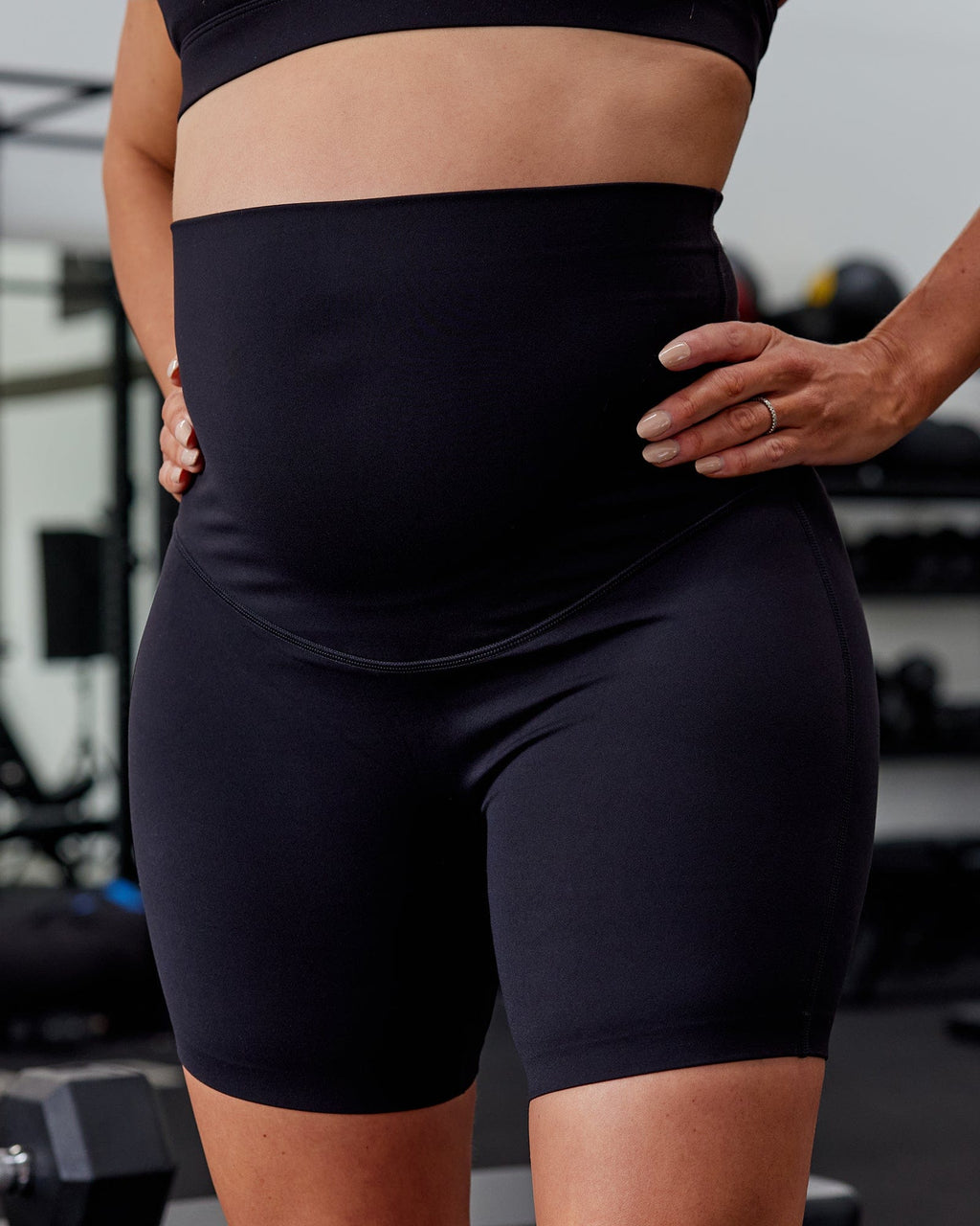 Woman wearing Elixir Mid Short Maternity Tight - Black