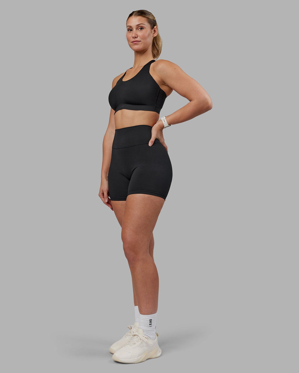 Woman wearing Stability Sports Bra - Black | Model:Amy | Size:M (D-E Cup)
