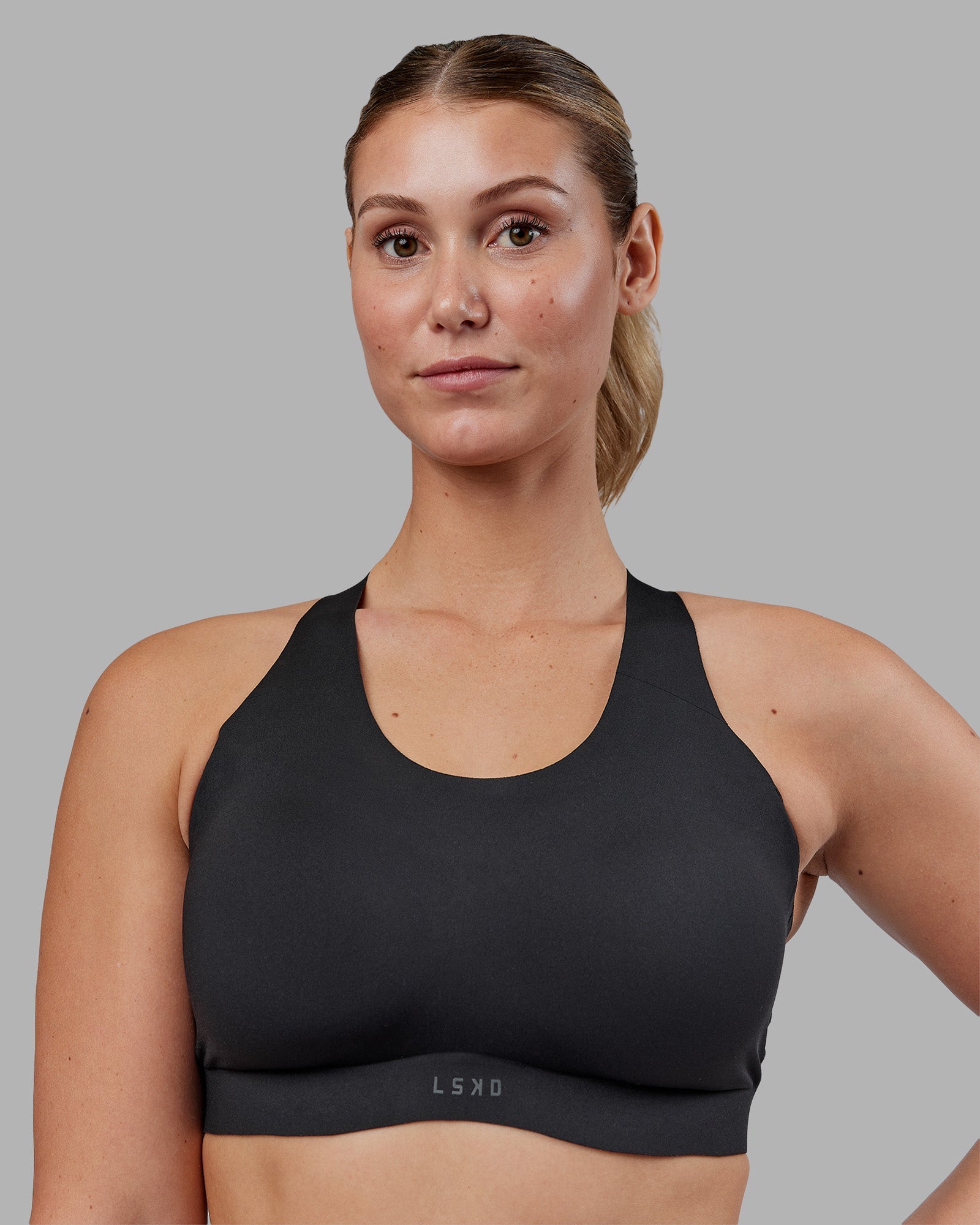 Woman wearing Stability Sports Bra - Black | Model:Amy | Size:M (D-E Cup)