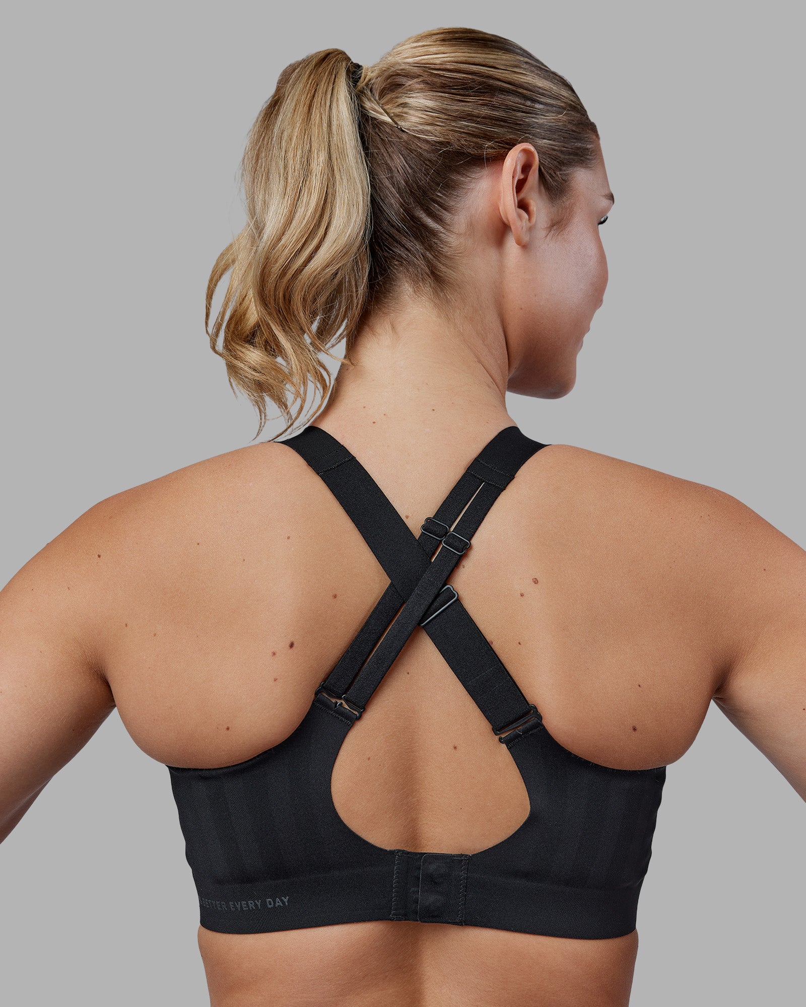 Woman wearing Stability Sports Bra - Black | Model:Amy | Size:M (D-E Cup)