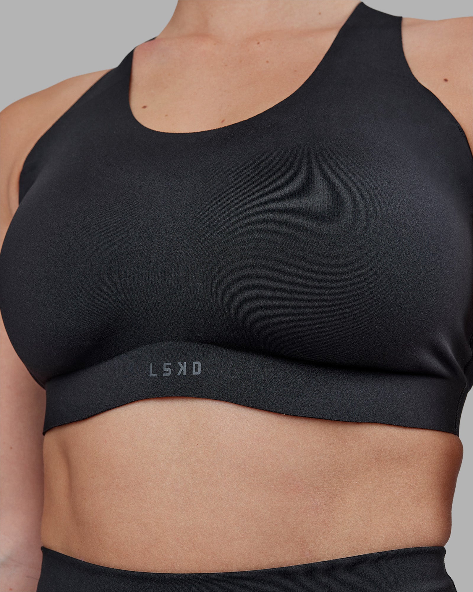 Woman wearing Stability Sports Bra - Black | Model:Amy | Size:M (D-E Cup)