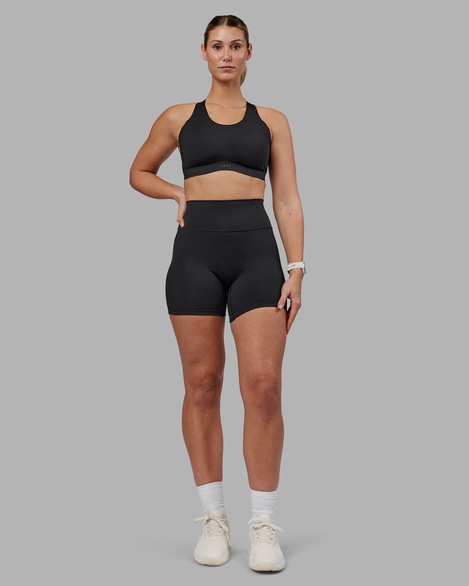 Woman wearing Stability Sports Bra - Black | Model:Amy | Size:M (D-E Cup)