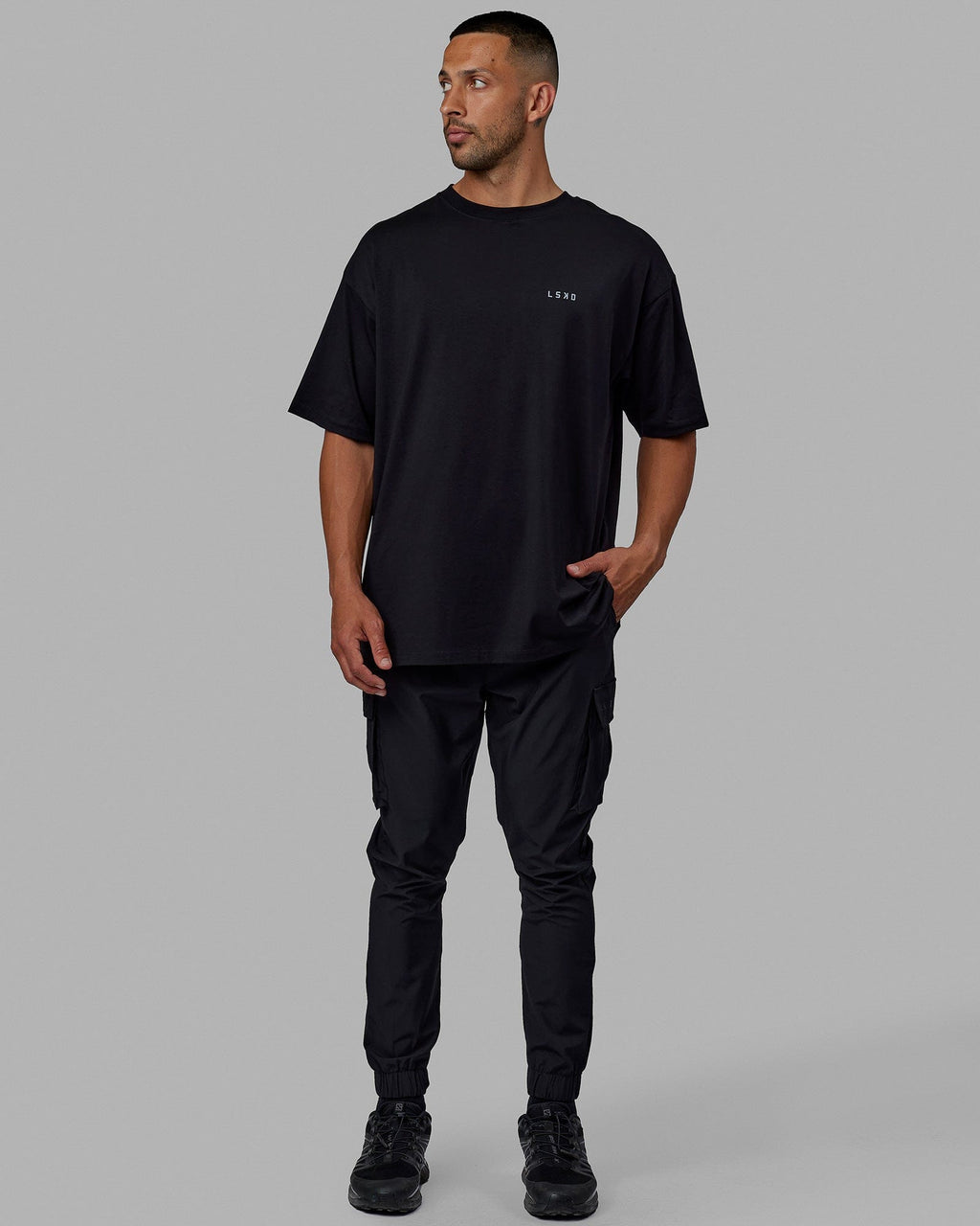 Man wearing Unisex PimaFLX Tee Oversize - Black