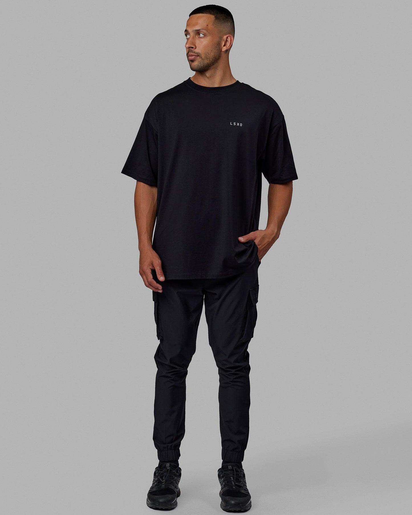 Man wearing Unisex PimaFLX Tee Oversize - Black