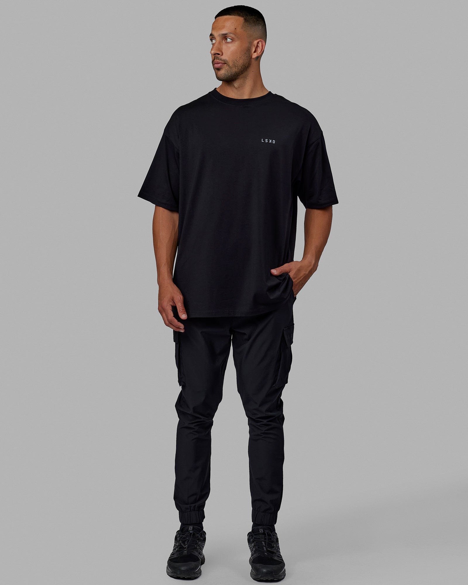 Man wearing Unisex PimaFLX Tee Oversize - Black