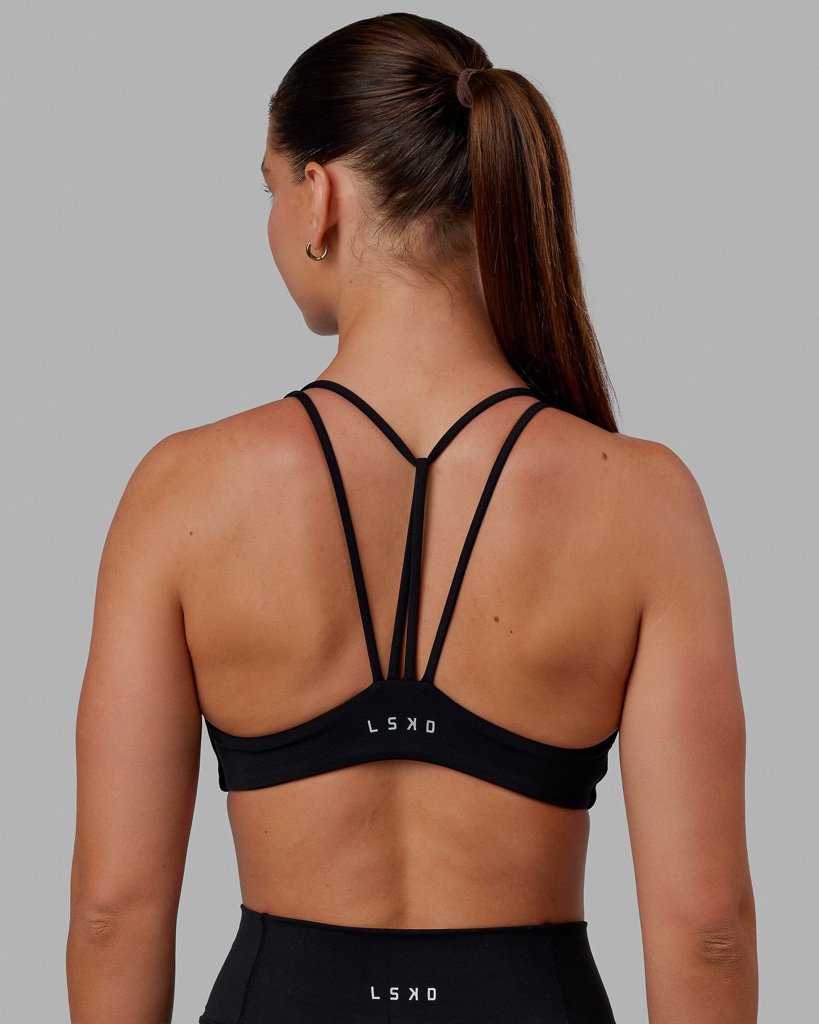Woman wearing Agile Sports Bra - Black