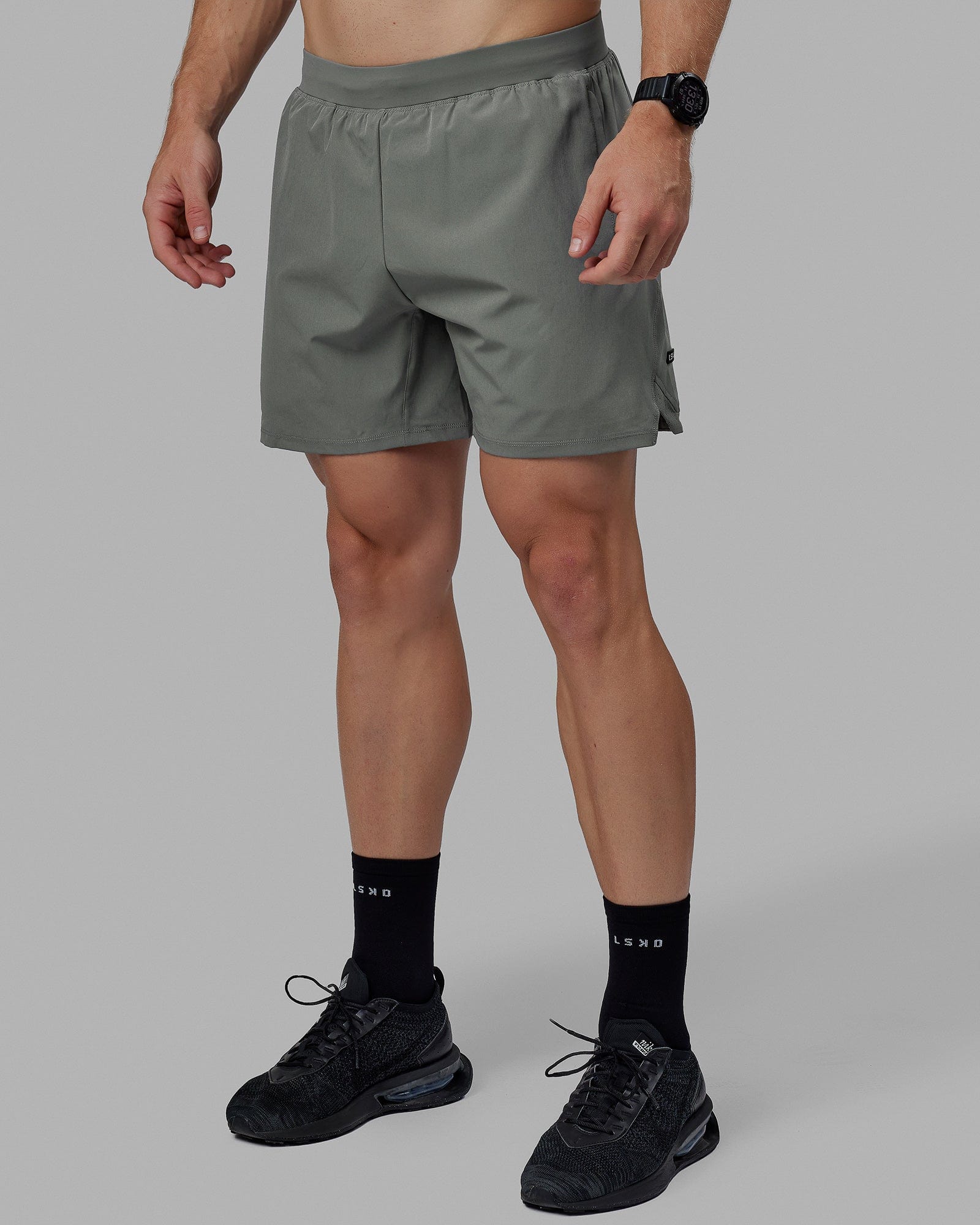 Man wearing Challenger 6" Lined Performance Shorts - Graphite