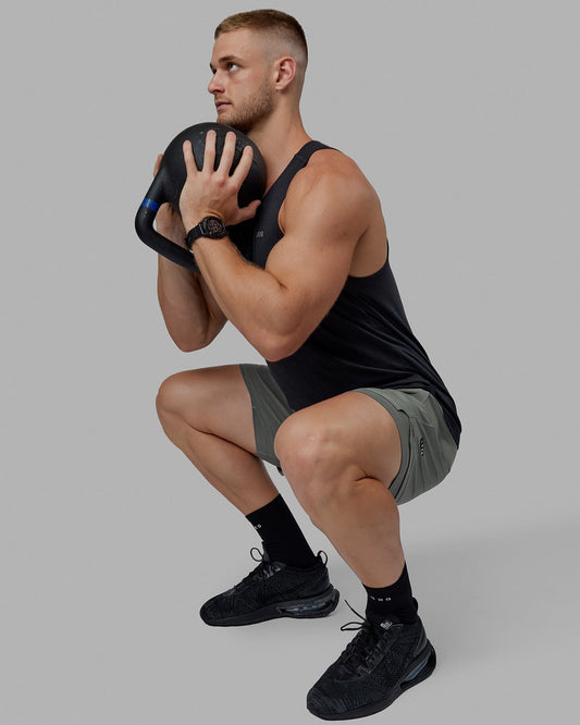 Man wearing Challenger 6" Lined Performance Shorts - Graphite