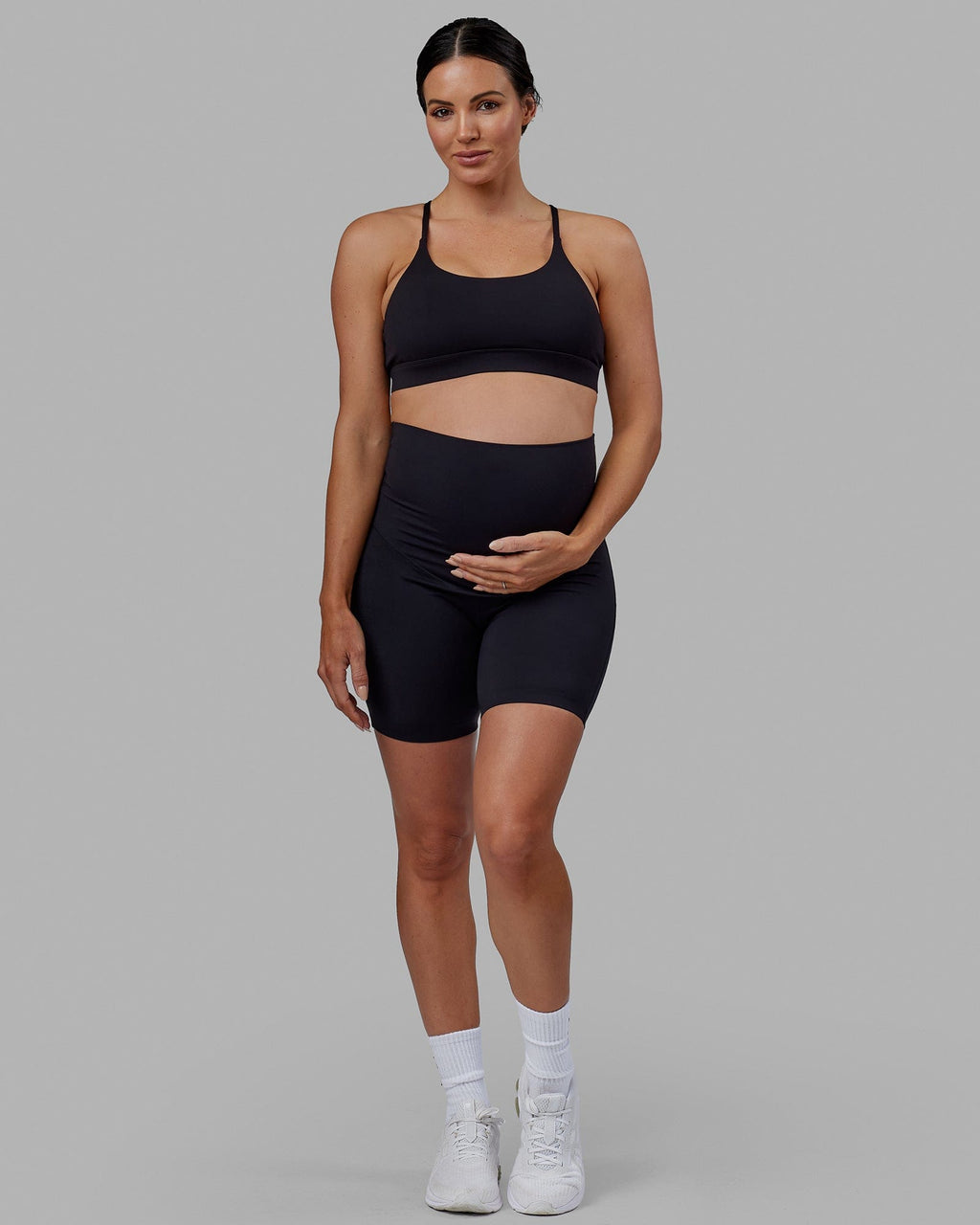 Woman wearing Elixir Mid Short Maternity Tight - Black