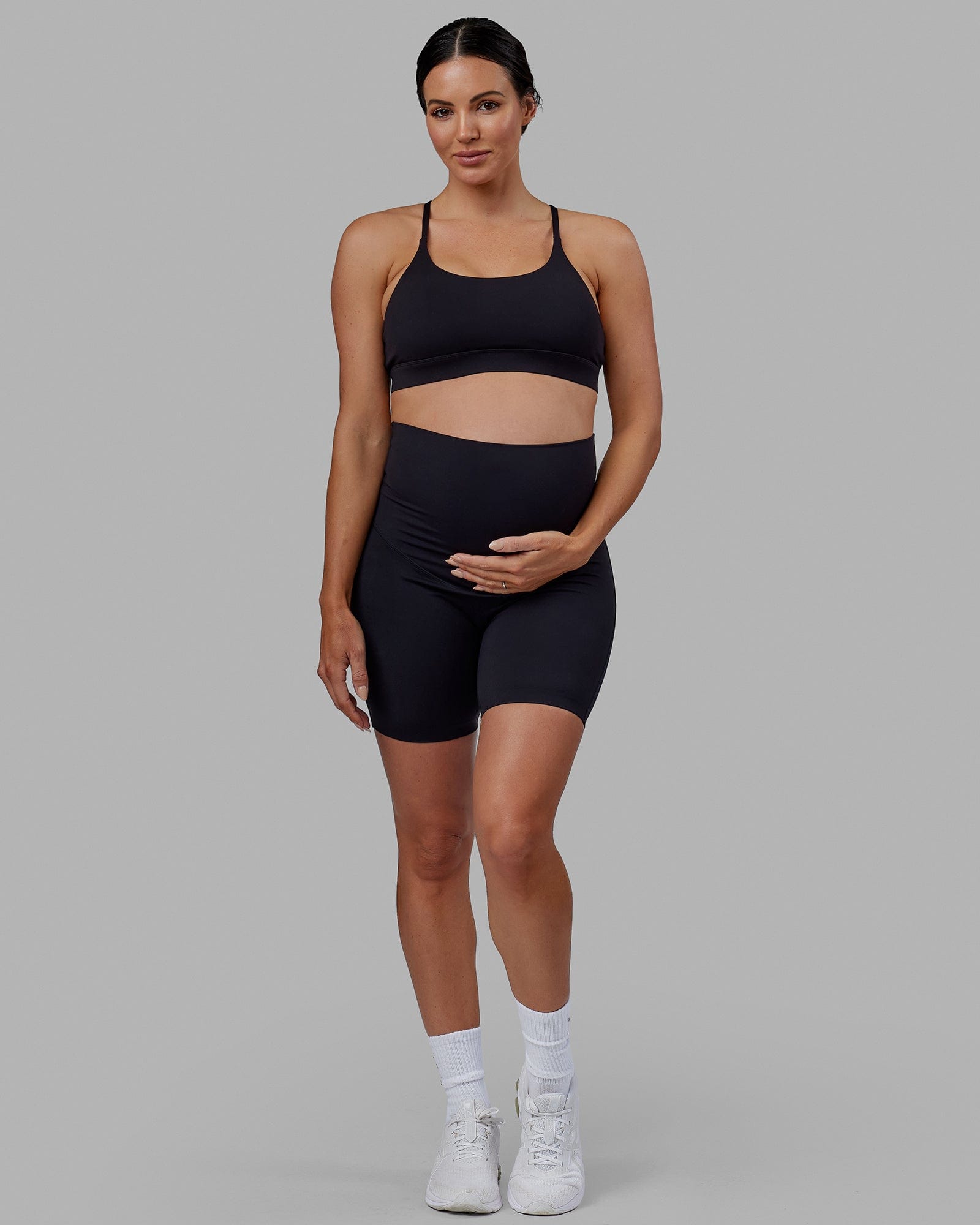 Woman wearing Elixir Mid Short Maternity Tight - Black