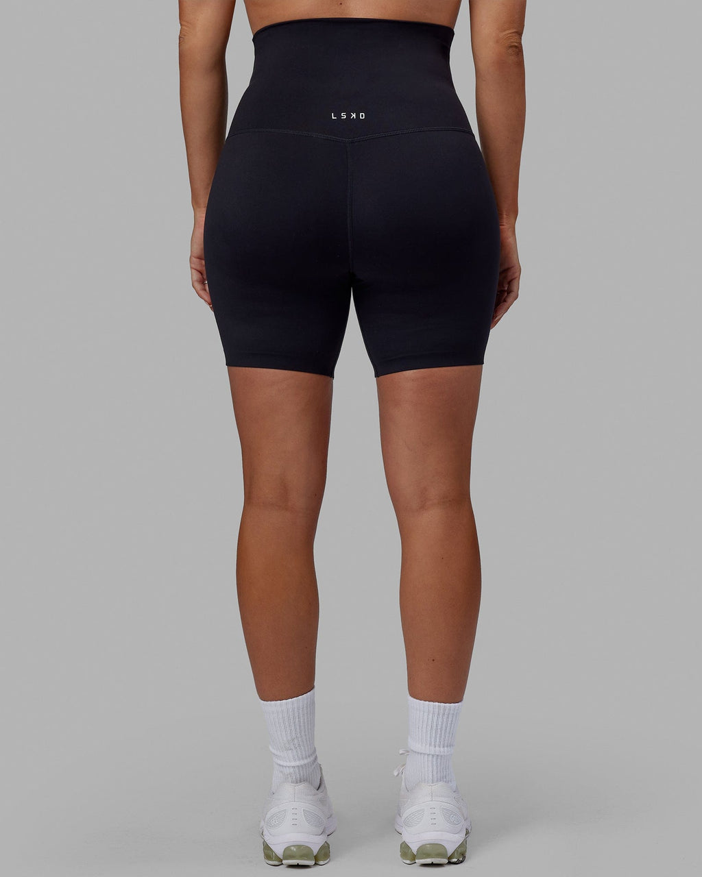 Woman wearing Elixir Mid Short Maternity Tight - Black