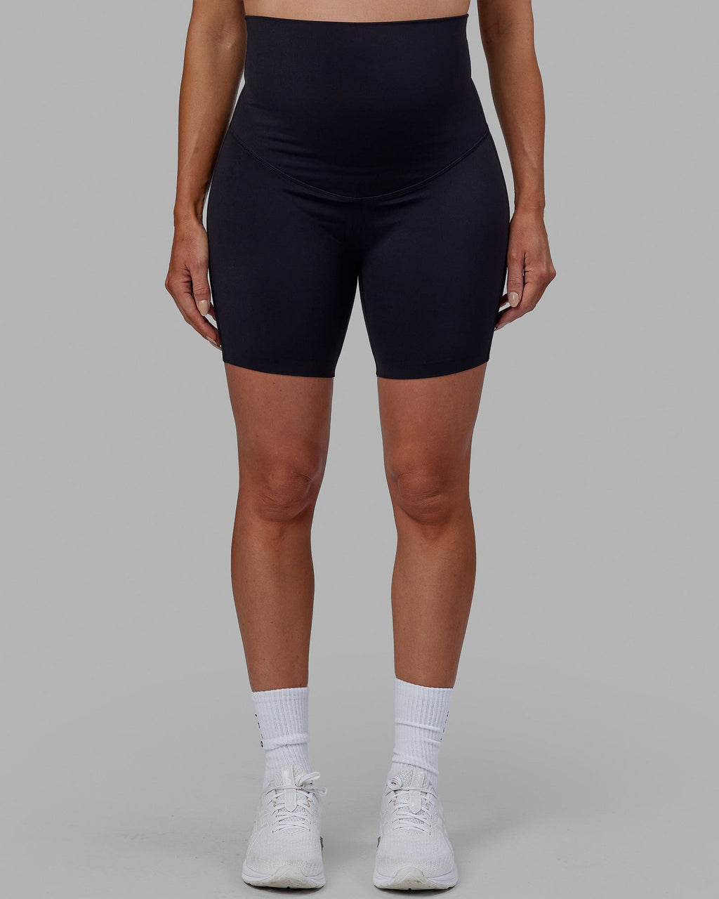 Woman wearing Elixir Mid Short Maternity Tight - Black