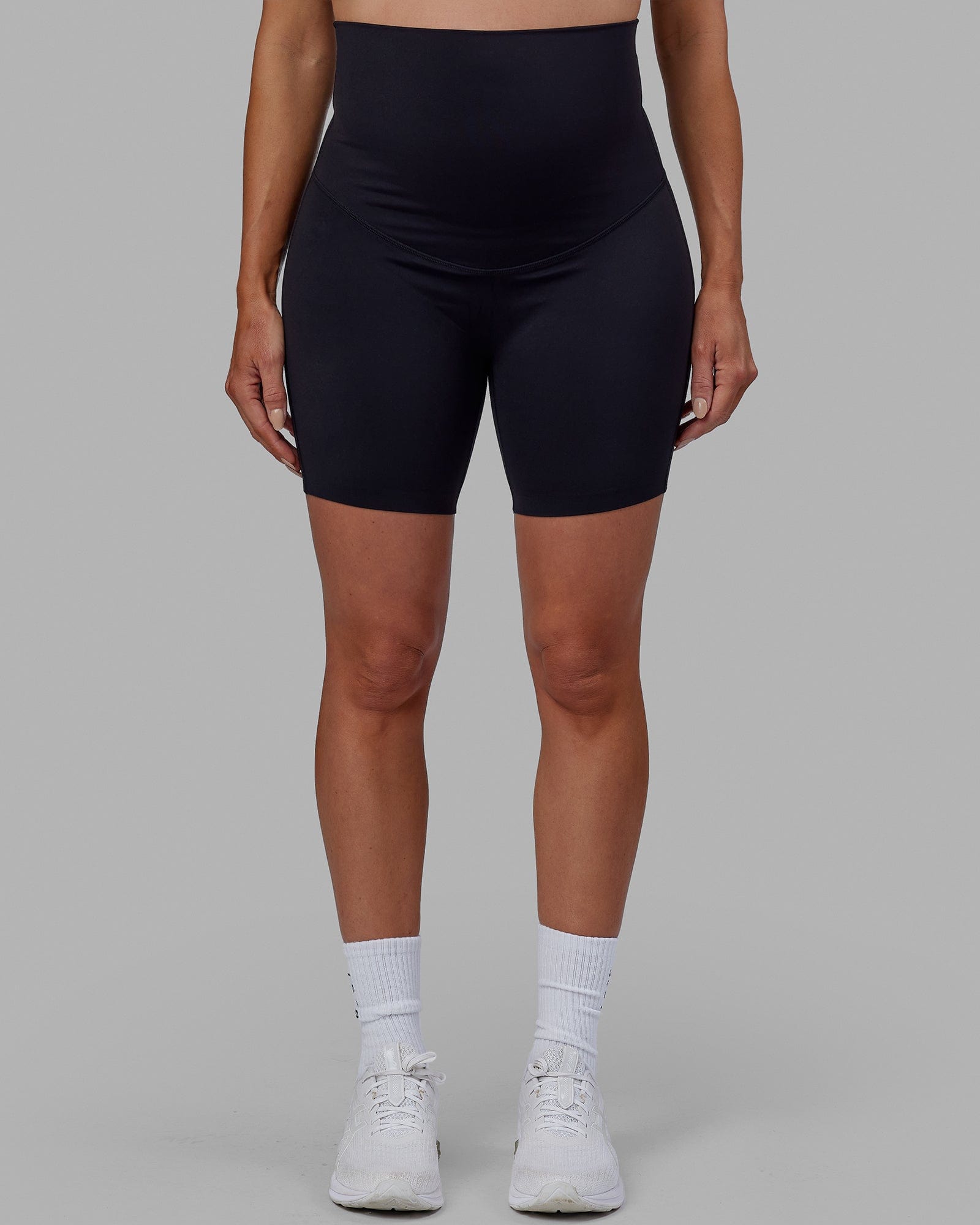 Woman wearing Elixir Mid Short Maternity Tight - Black