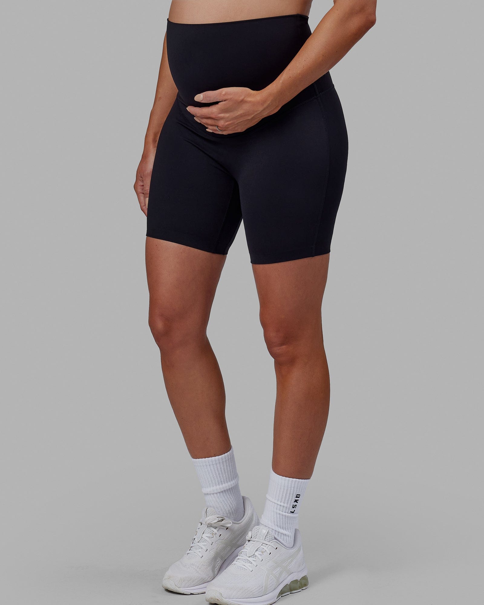 Woman wearing Elixir Mid Short Maternity Tight - Black