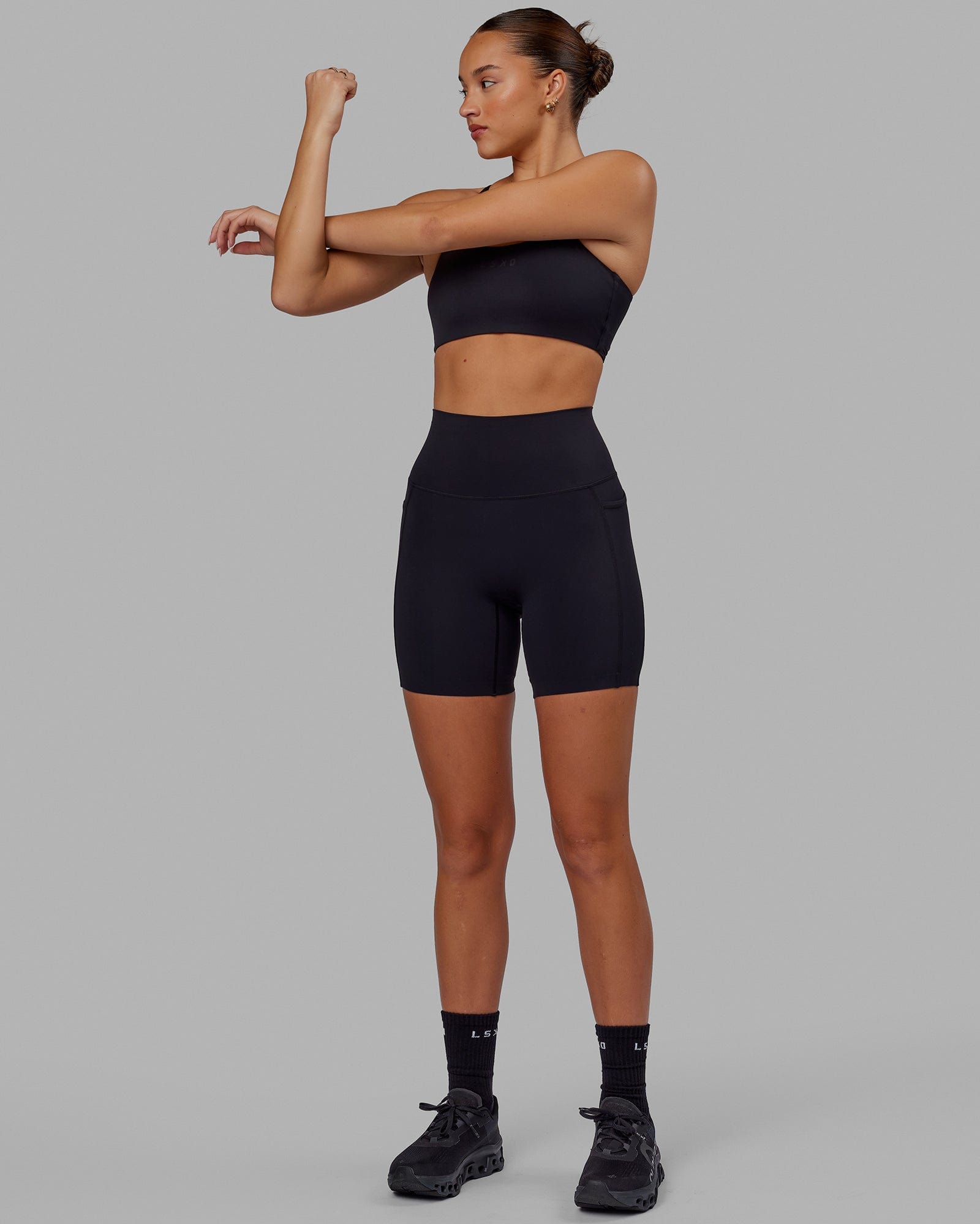 Woman wearing Elixir Mid Short Tight with Pockets - Black