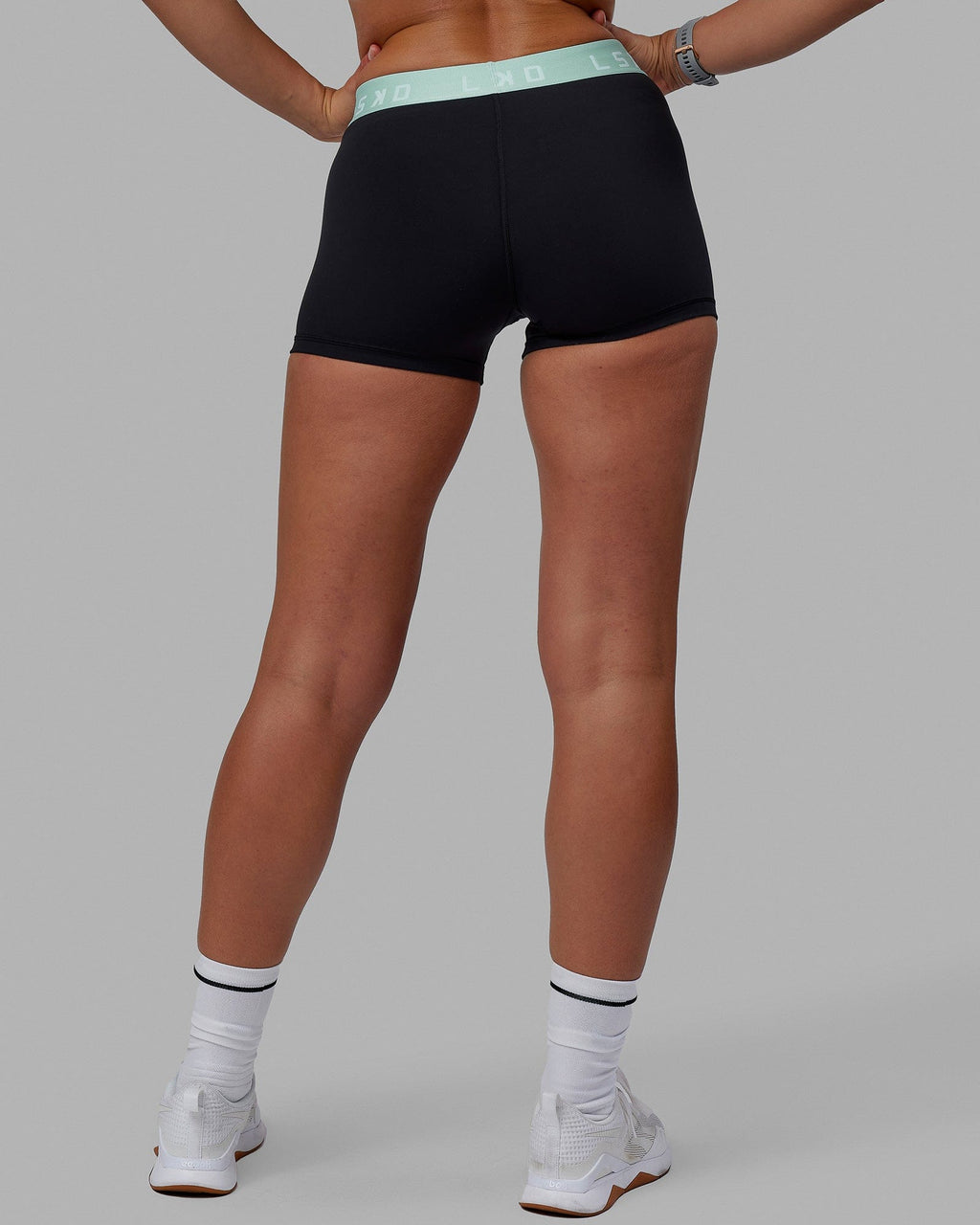 Woman wearing Extend X-Short Tights - Black-Pastel Turquoise