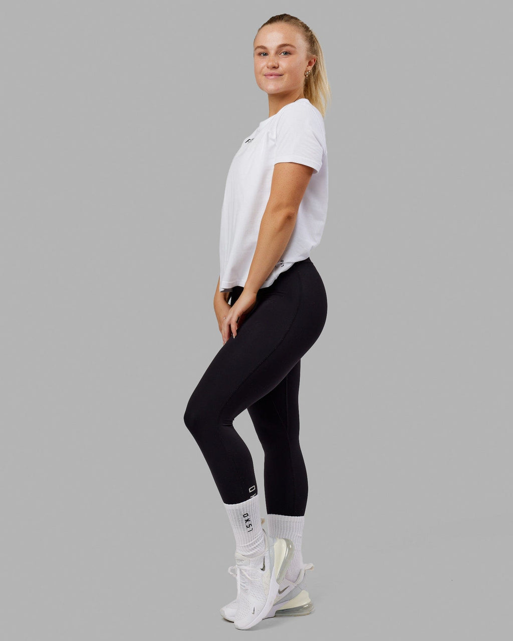 Woman wearing Fitstop Fast Tee - White