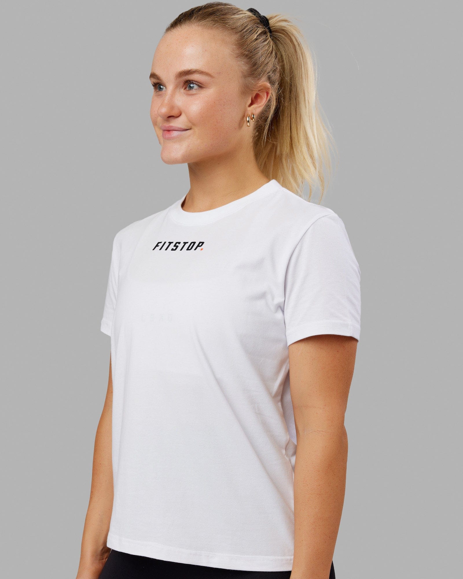 Woman wearing Fitstop Fast Tee - White