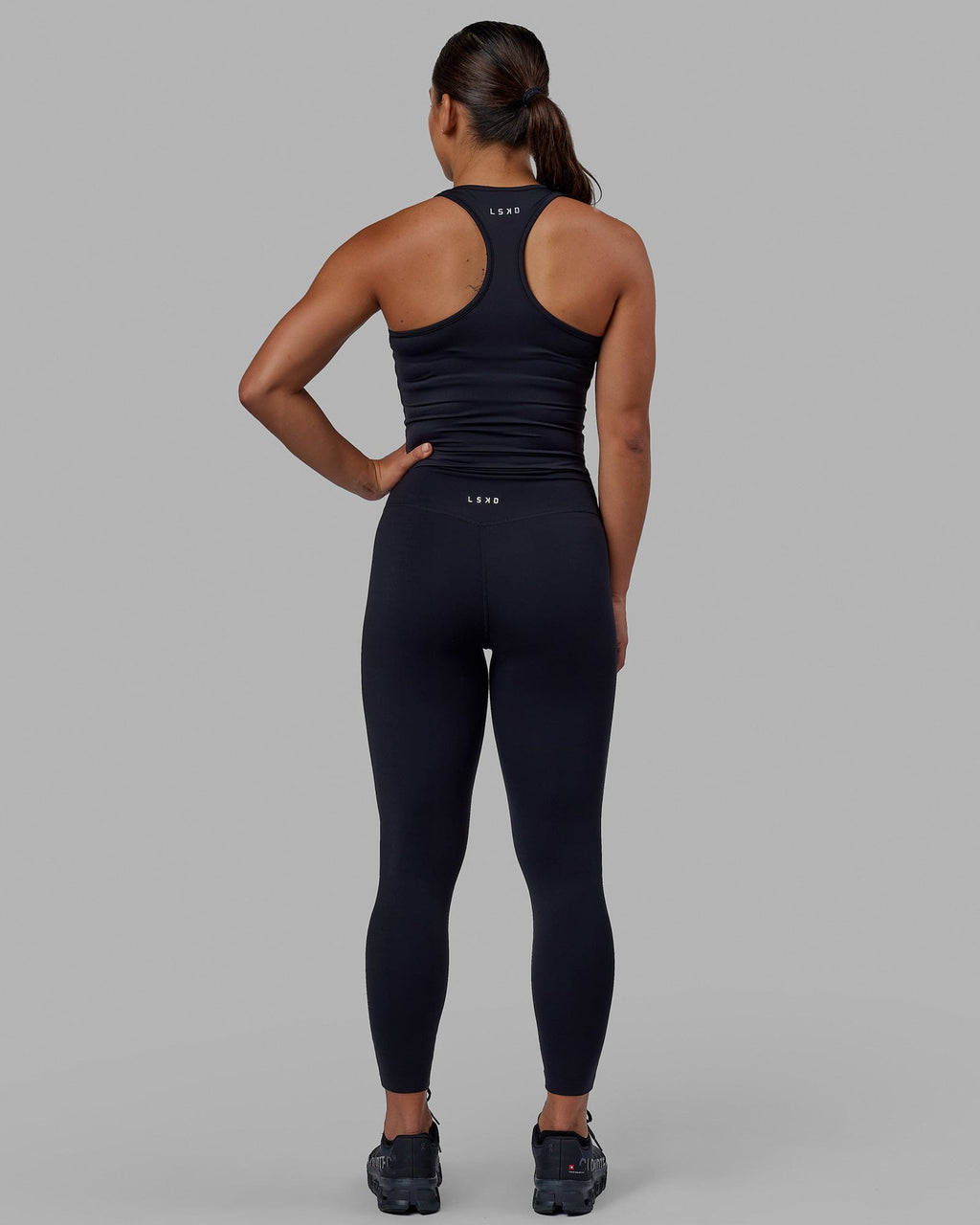 Woman wearing Flow Performance Tank - Black