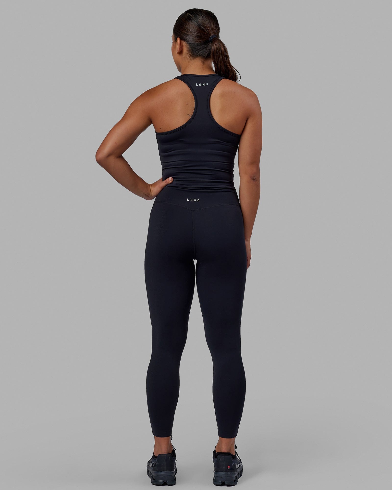 Woman wearing Flow Performance Tank - Black