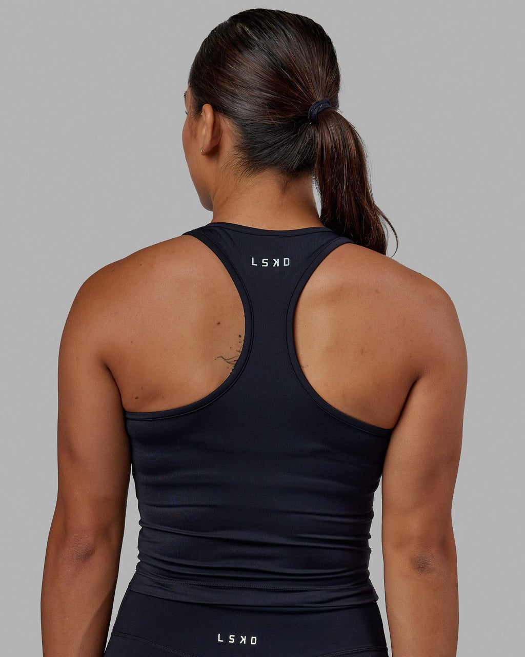 Woman wearing Flow Performance Tank - Black