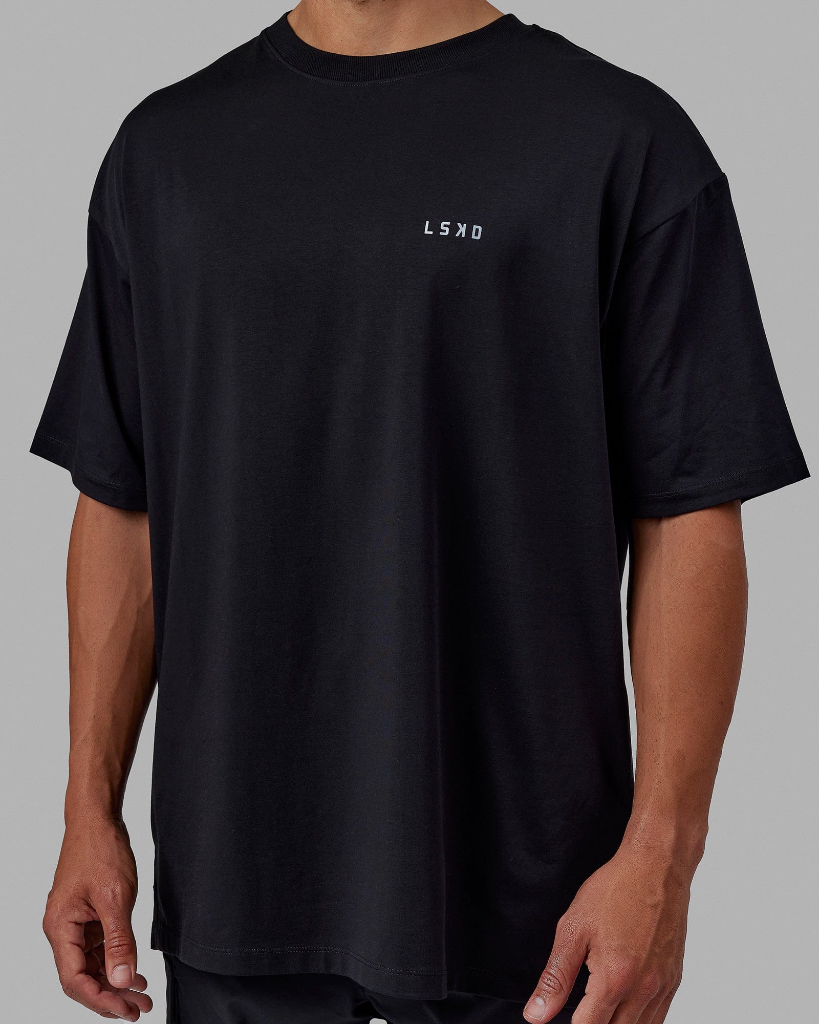 Man wearing Unisex PimaFLX Tee Oversize - Black