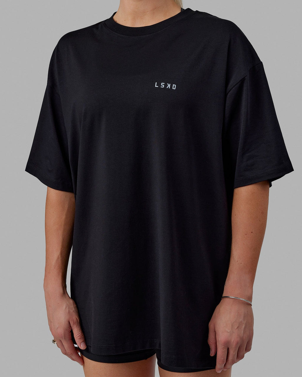 Woman wearing Unisex PimaFLX Tee Oversize - Black
