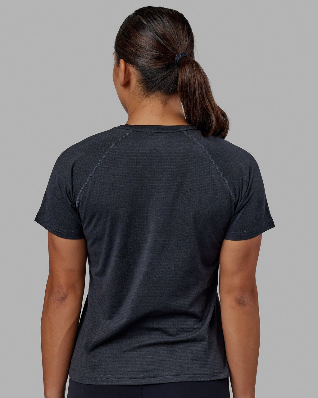 Woman wearing Perform VapourFLX Tee - Black Marl