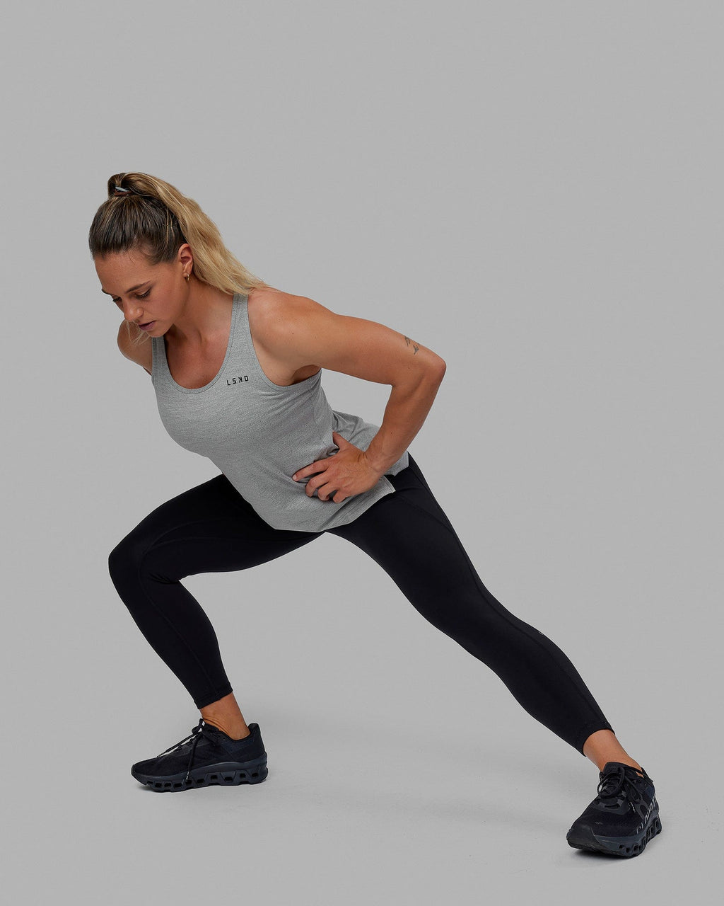 Woman wearing Perform VapourFLX Tank - Lt Grey Marl