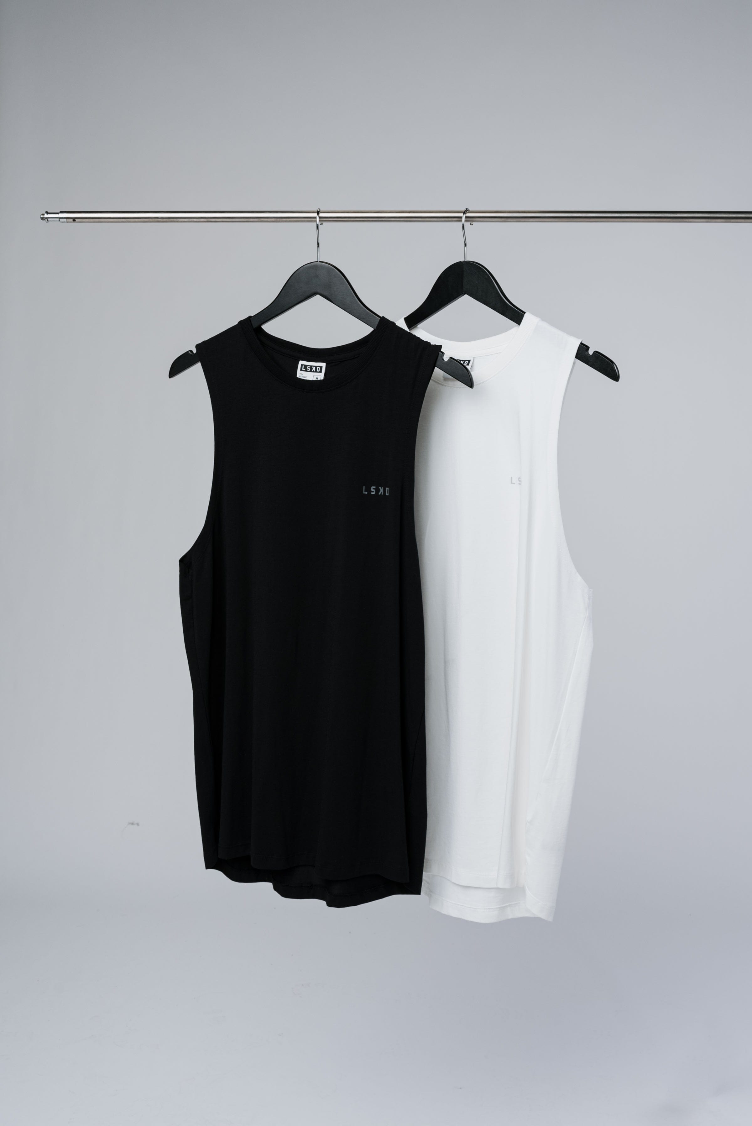 Model wearing 2 For $95 Mens Deluxe PimaFLX Tanks