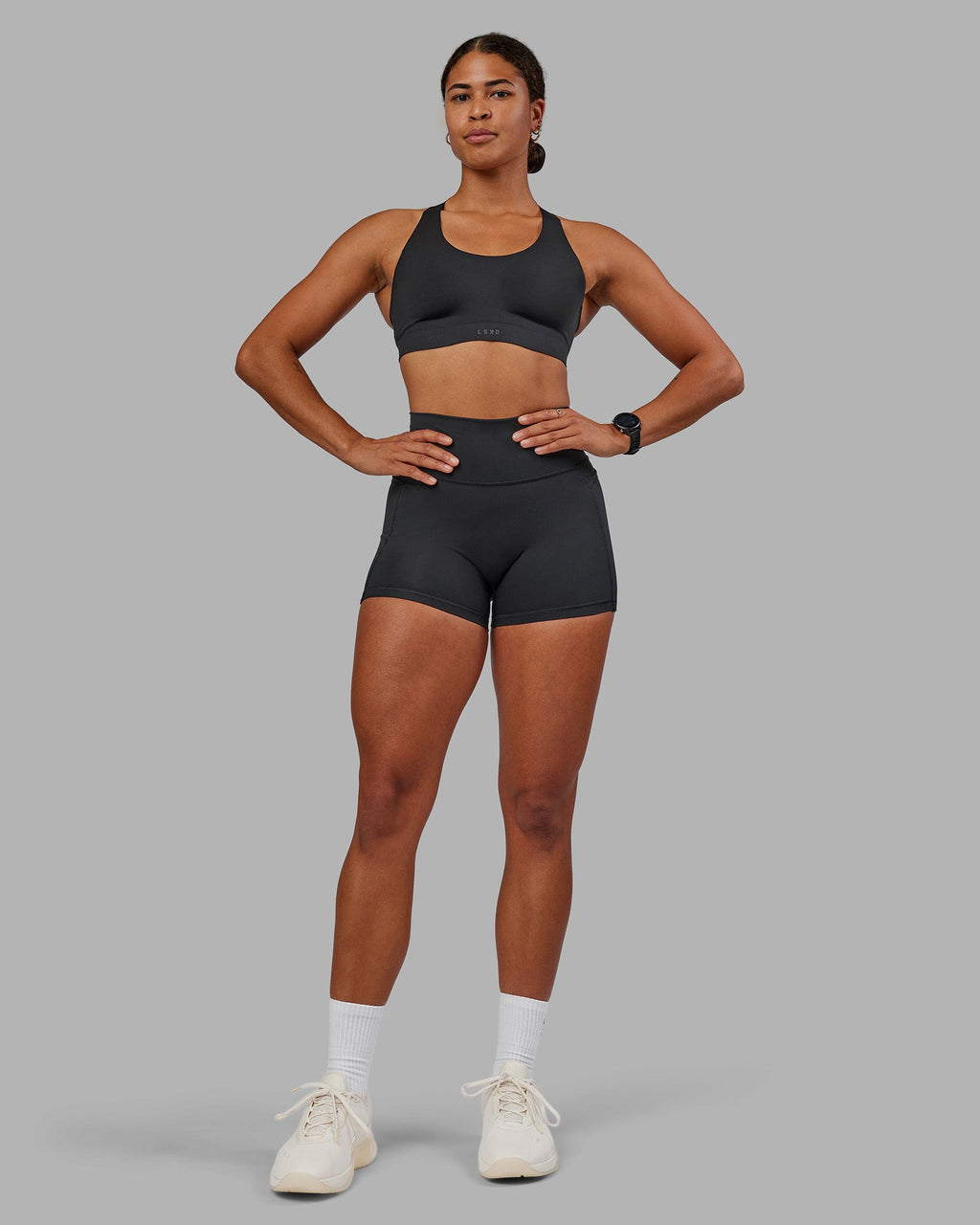 Woman wearing Stability Sports Bra - Black | Model:Janet | Size:S (A-C Cup)