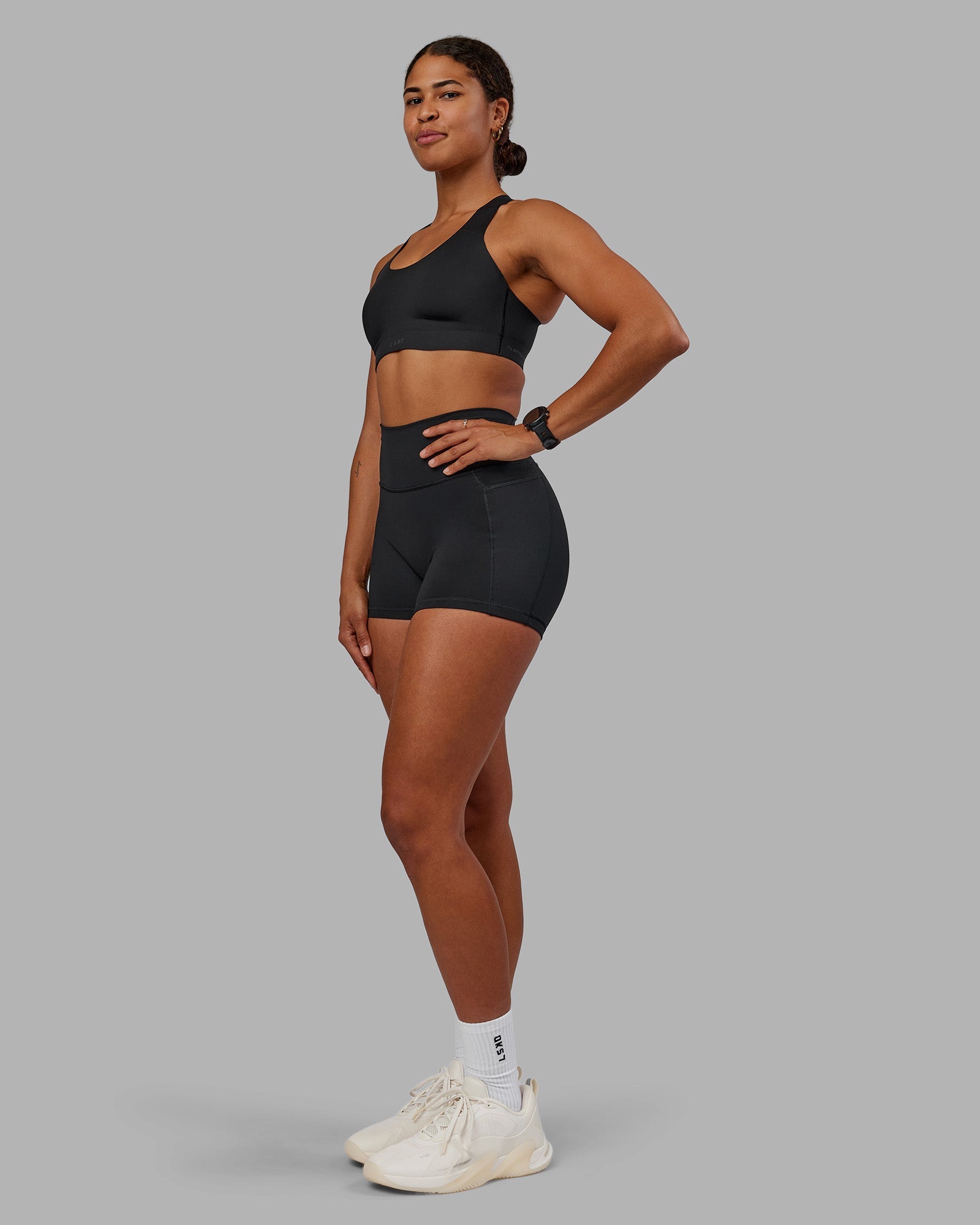 Woman wearing Stability Sports Bra - Black | Model:Janet | Size:S (A-C Cup)