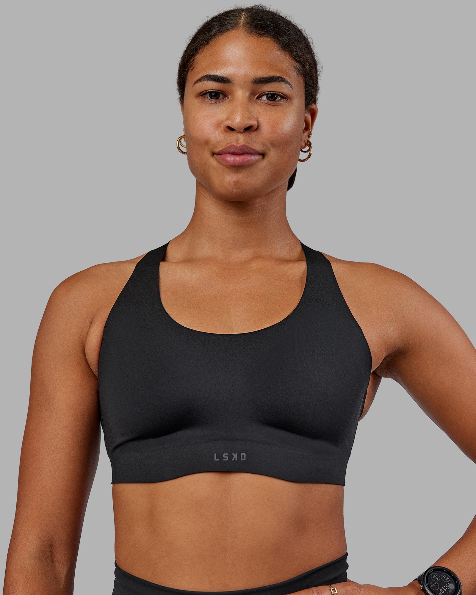 Woman wearing Stability Sports Bra - Black | Model:Janet | Size:S (A-C Cup)