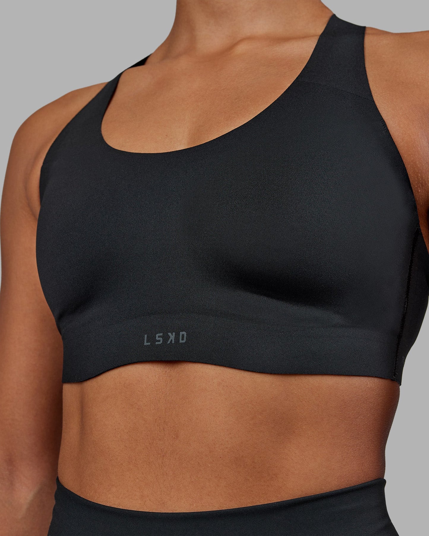 Woman wearing Stability Sports Bra - Black | Model:Janet | Size:S (A-C Cup)