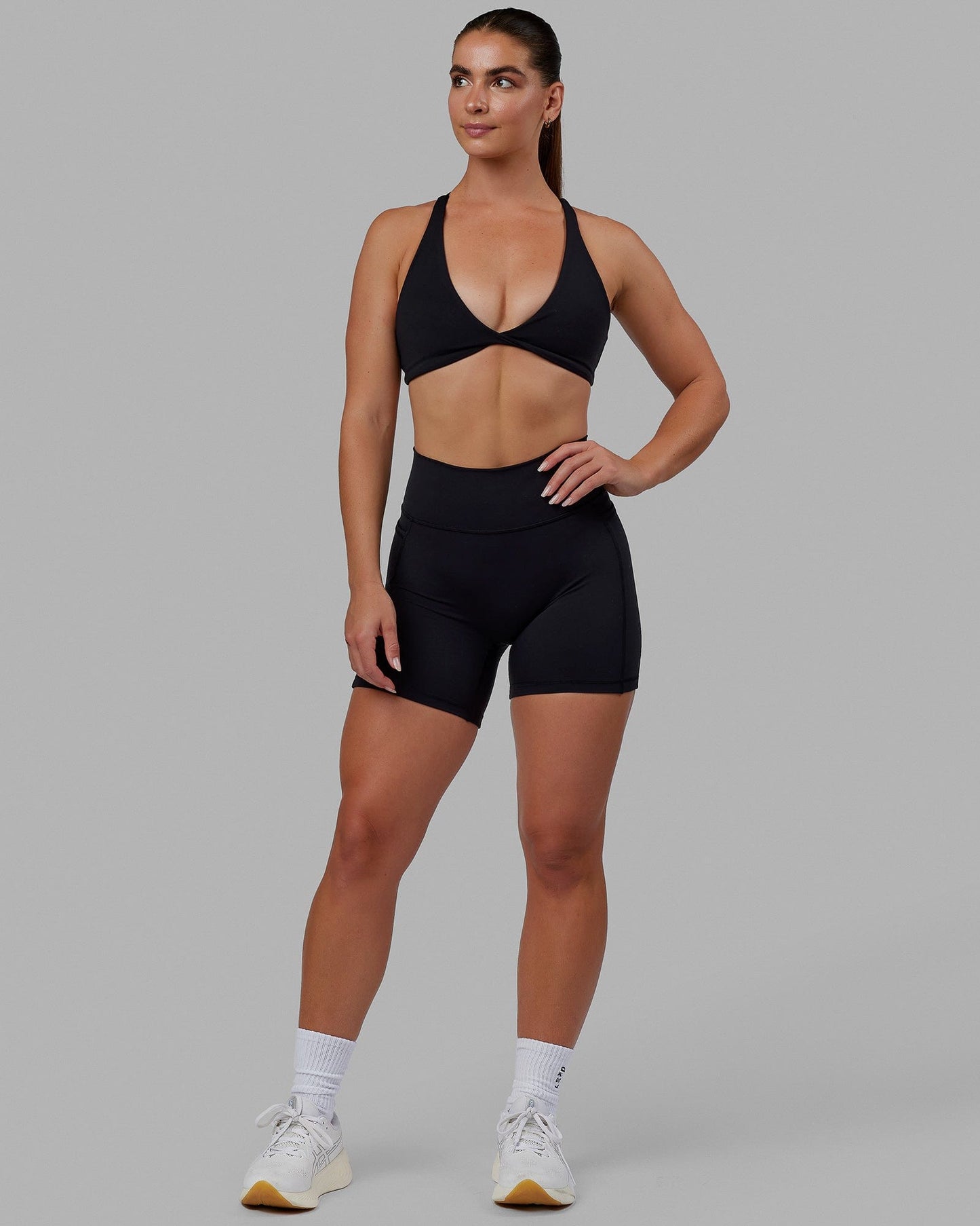 Woman wearing Agile Sports Bra - Black