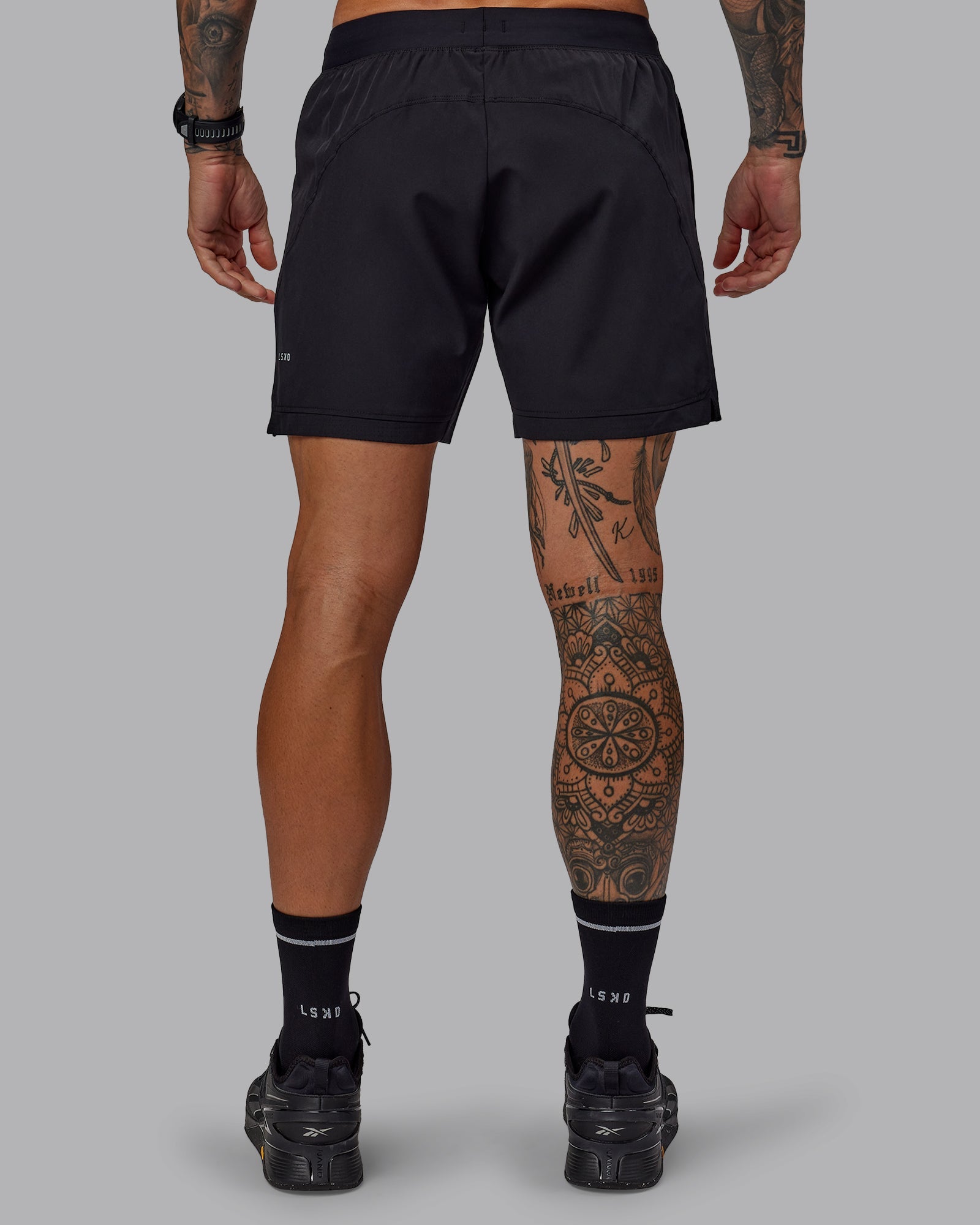 Man wearing Challenger 6" Performance Shorts in Black | Size:S