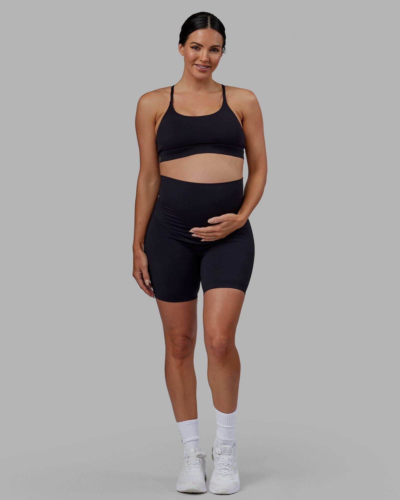 Woman wearing Elixir Mid Short Maternity Tight - Black