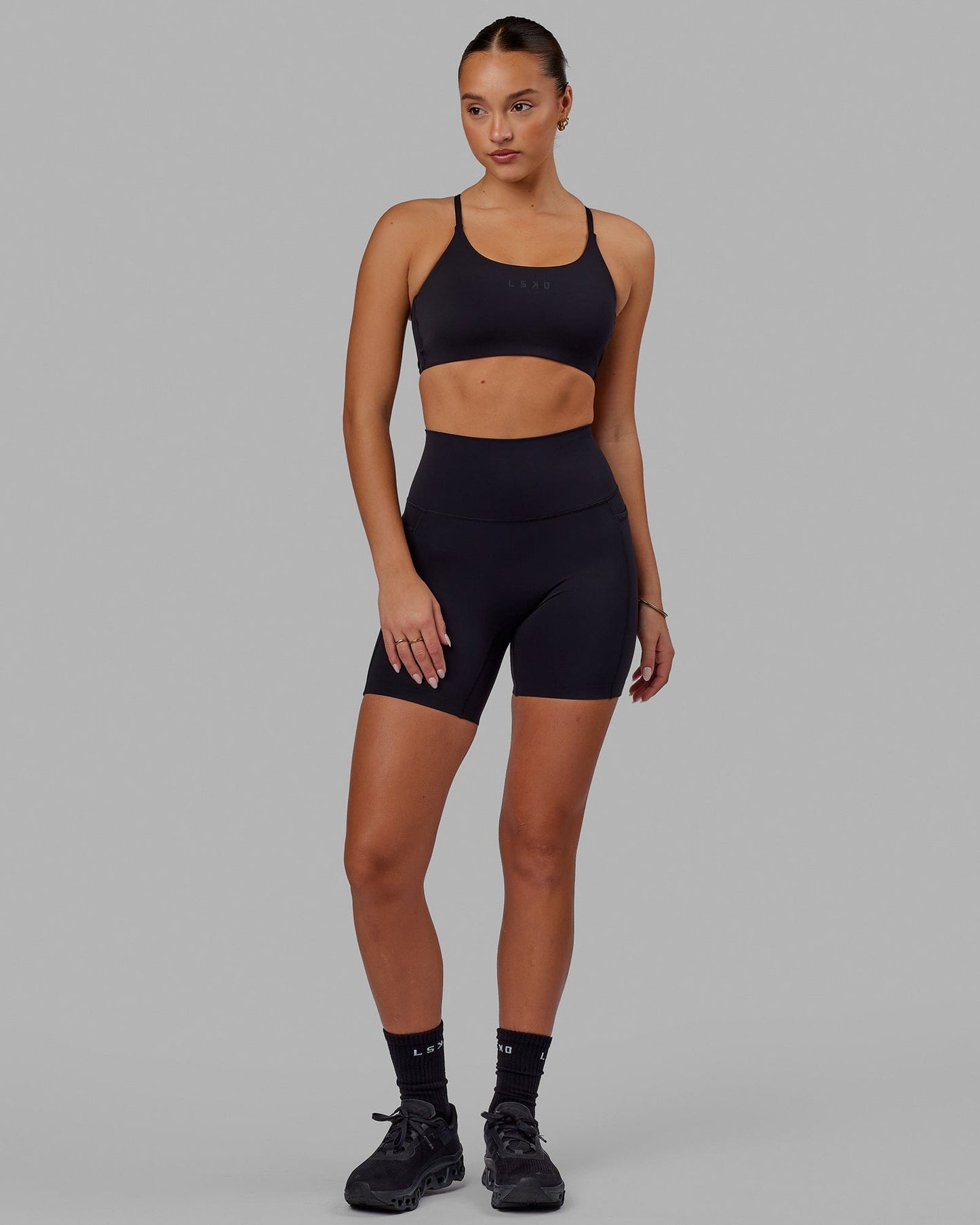 Woman wearing Elixir Mid Short Tight with Pockets - Black