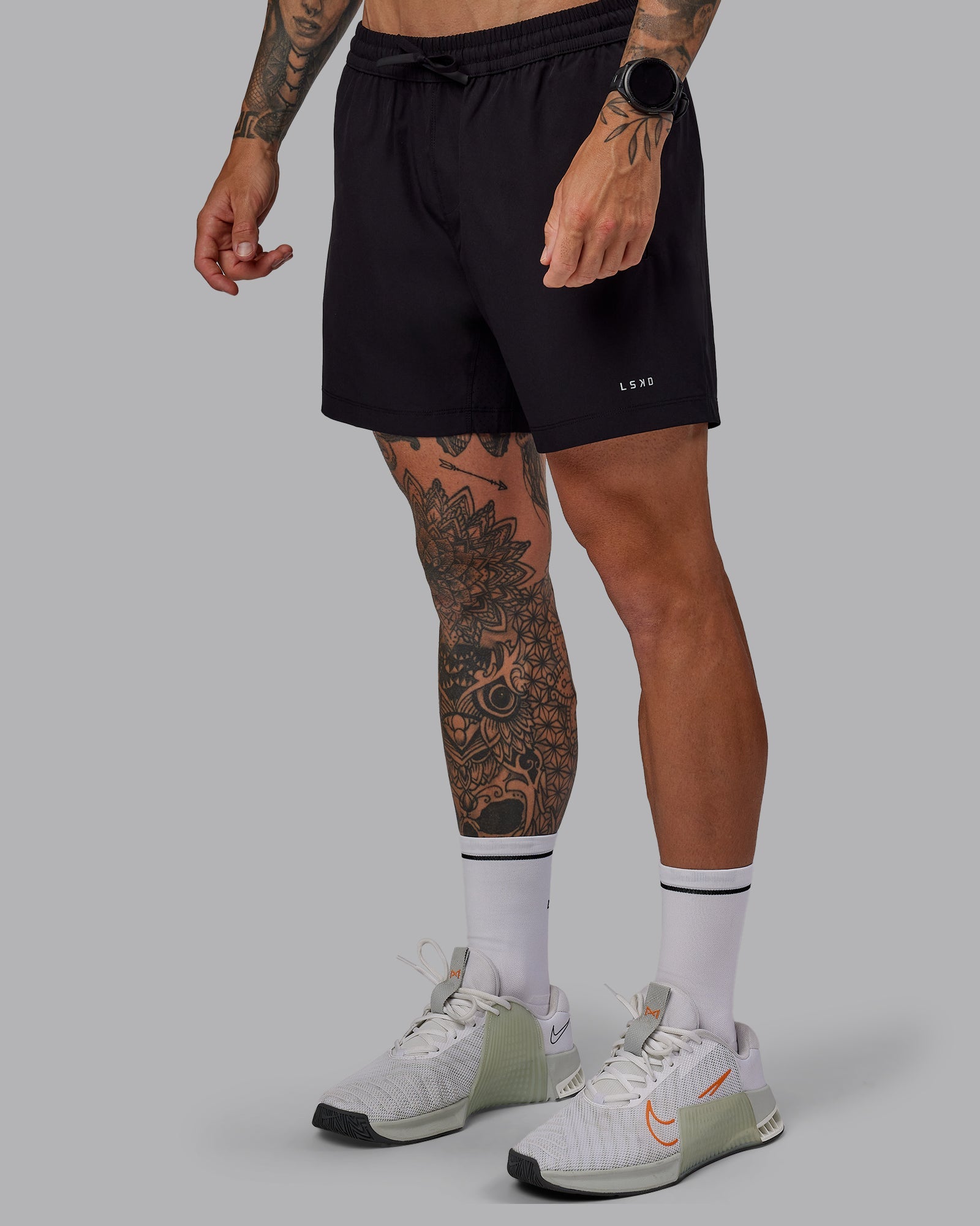 Man wearing Rep 5" Lined Performance Shorts in Black | Size:S