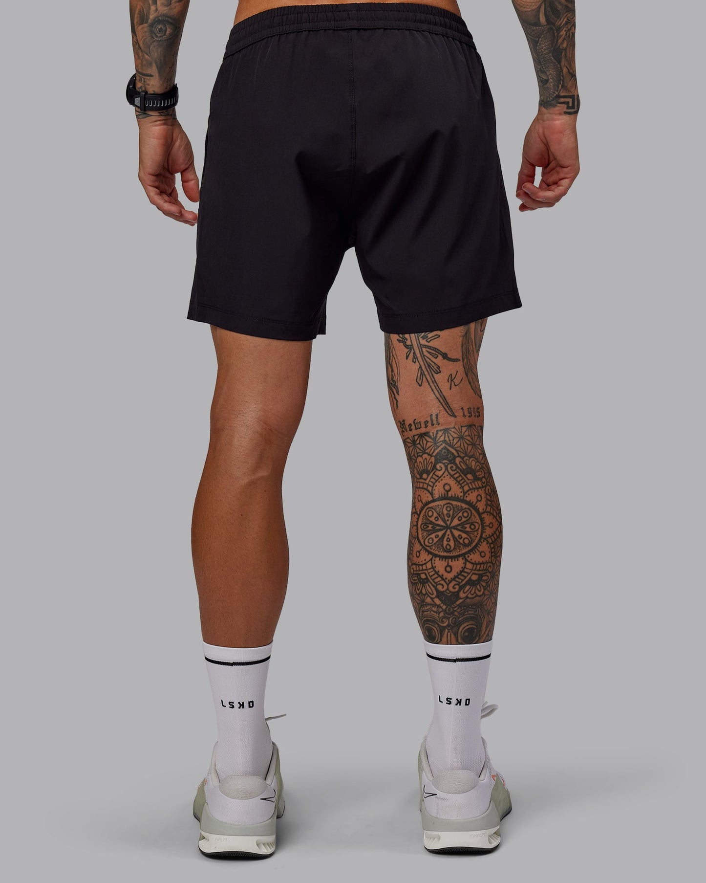 Man wearing Rep 5" Lined Performance Shorts in Black | Size:S