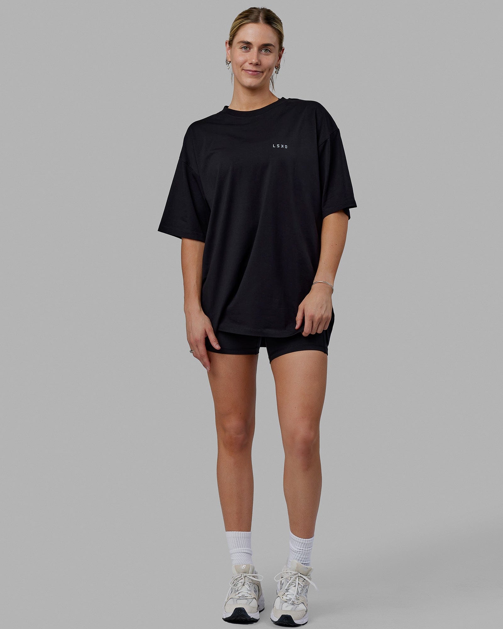Woman wearing Unisex PimaFLX Tee Oversize - Black