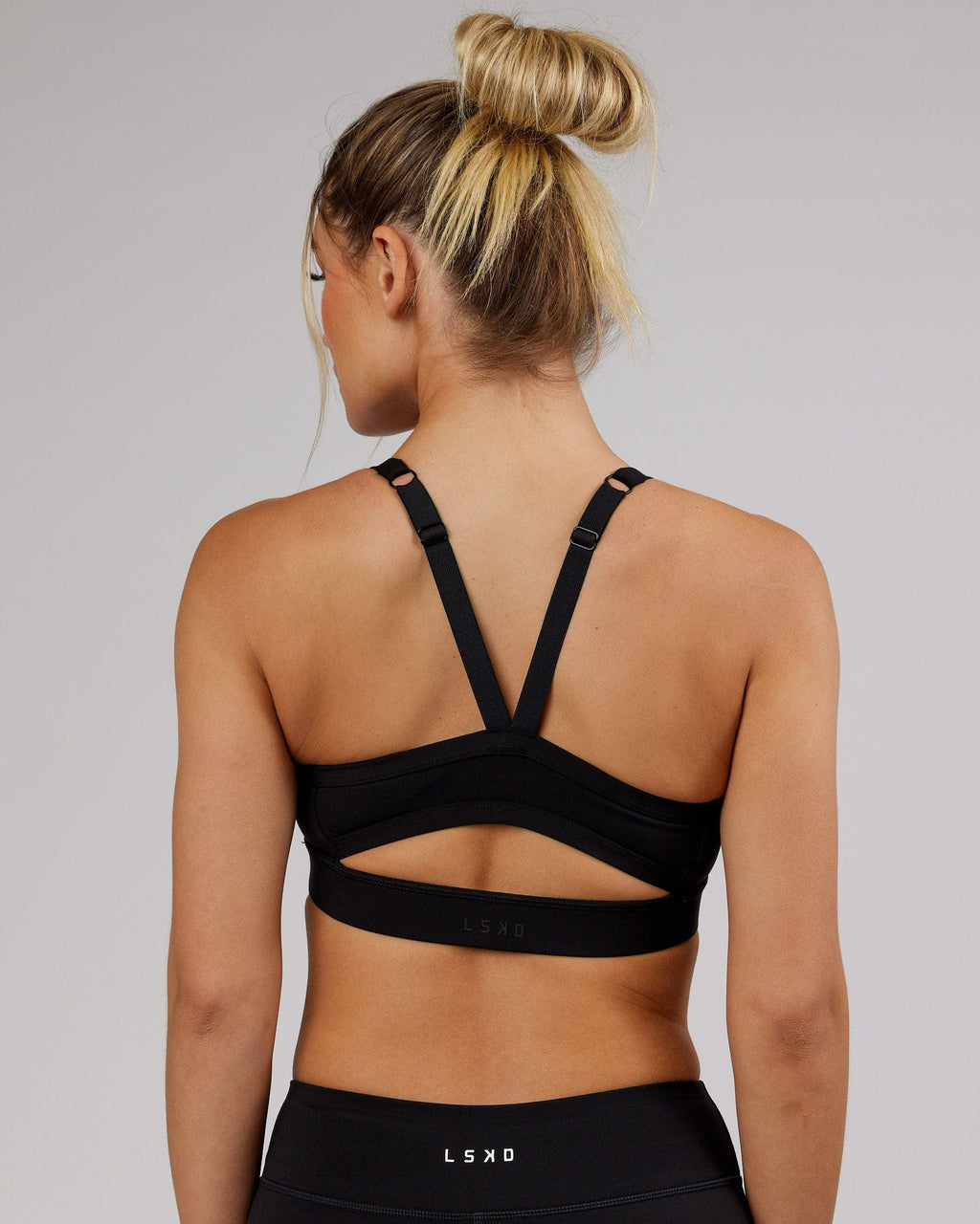 Woman wearing Momentum Sports Bra - Black